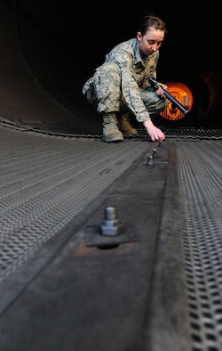 WHITEMAN AIR FORCE BASE, Mo. -- Senior Airman Kaitlyn Fawber, 509th Maintenance Squadron aerospace propulsion journeyman, inspects a test cell rivet, Feb. 13. The test cell is a $2.9-million-facility used by jet engine mechanics to test the serviceability of jet engines. (U.S. Air Force photo/Staff Sgt. Nick Wilson) (Released)