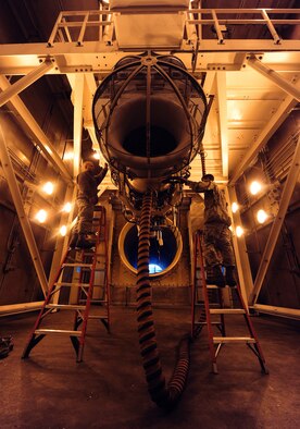 WHITEMAN AIR FORCE BASE, Mo. -- Staff Sgt. Eric Barnes, 509th Maintenance Squadron test cell assistant section chief, and Airman 1st Class Lester Popham, 509th MXS aerospace propulsion apprentice, close an inlet bell mouth for a B-2 Spirit engine inside the test cell, Feb. 13. The inlet bell mouth distributes and guides air into the motor to allow the engine to run smoothly in the test cell. (U.S. Air Force photo/Staff Sgt. Nick Wilson) (Released)