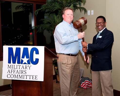 Mr. Alfred McCambry accepts the role as the new Military Affairs Committee Chair for the Bay County Chamber of Commerce by outgoing MAC Chairman, Mr. David Powell, during a ceremony Feb. 6 in downtown Panama City, Fla. (U.S. Air Force photo by Lisa Norman)