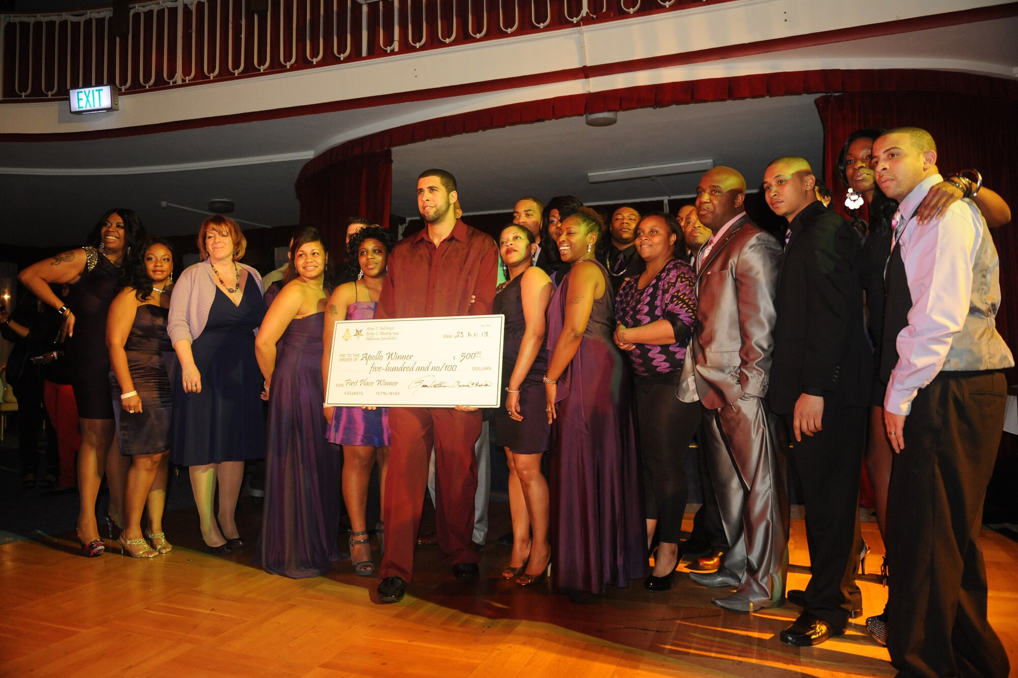 John Snow, drum instructor at the Vogelweh and Ramstein community centers, poses after winning the prize, a $500 check during Apollo Night at the Armstrong Club on Vogelweh Military Complex, Germany, Feb. 23, 2013. Apollo Night in the Kaiserslautern Military Community traces its roots to the original event in Harlem New York, and gives members of the KMC a chance to do something out of the ordinary. (U.S. Air Force photo/Senior Airman Aaron-Forrest Wainwright)