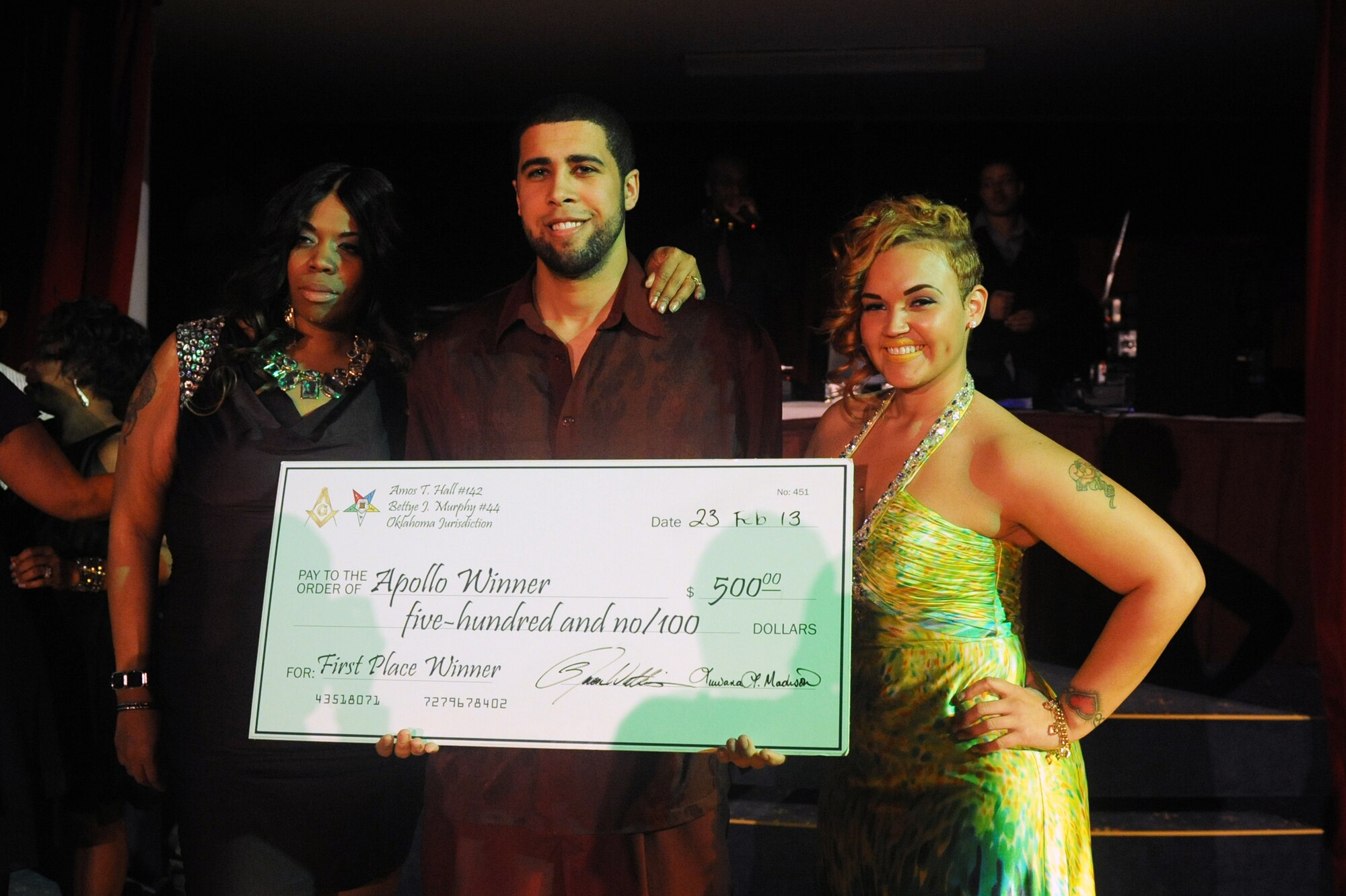 John Snow, drum instructor at the Vogelweh and Ramstein community centers, poses after winning the prize, a $500 check during Apollo Night at the Armstrong Club on Vogelweh Military Complex, Germany, Feb. 23, 2013. Apollo Night in the Kaiserslautern Military Community traces its roots to the original event in Harlem New York, and gives members of the KMC a chance to do something out of the ordinary. (U.S. Air Force photo/Senior Airman Aaron-Forrest Wainwright)