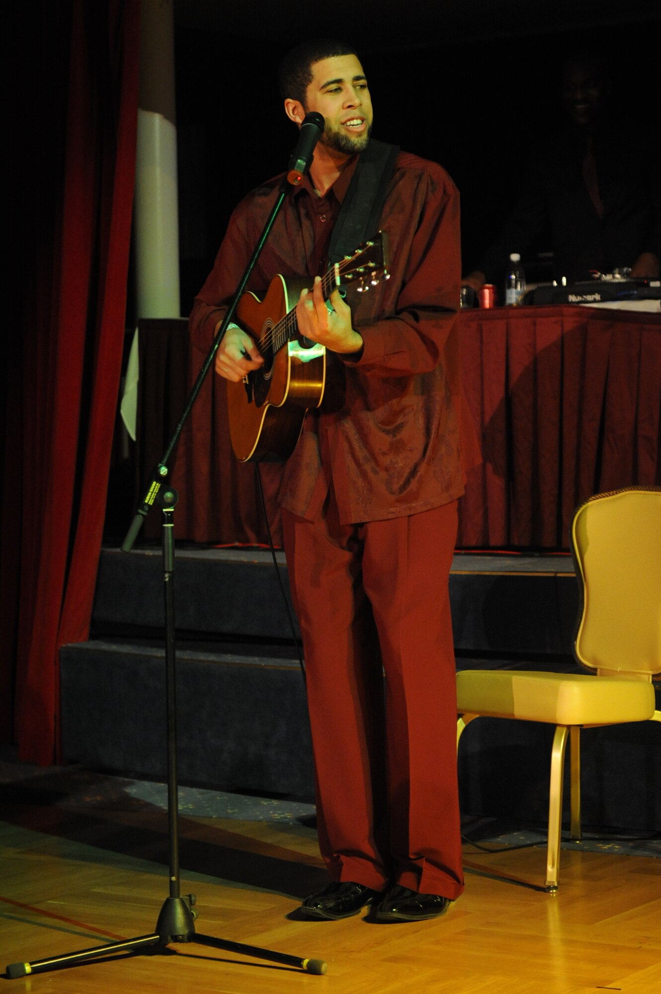 John Snow, drum instructor at the Vogelweh and Ramstein community centers, plays guitar and sings during Apollo Night at the Armstrong Club on Vogelweh Military Complex, Germany, Feb. 23, 2013. Apollo Night in the Kaiserslautern Military Community traces its roots to the original event in Harlem New York, and gives members of the KMC a chance to do something out of the ordinary. (U.S. Air Force photo/Senior Airman Aaron-Forrest Wainwright)