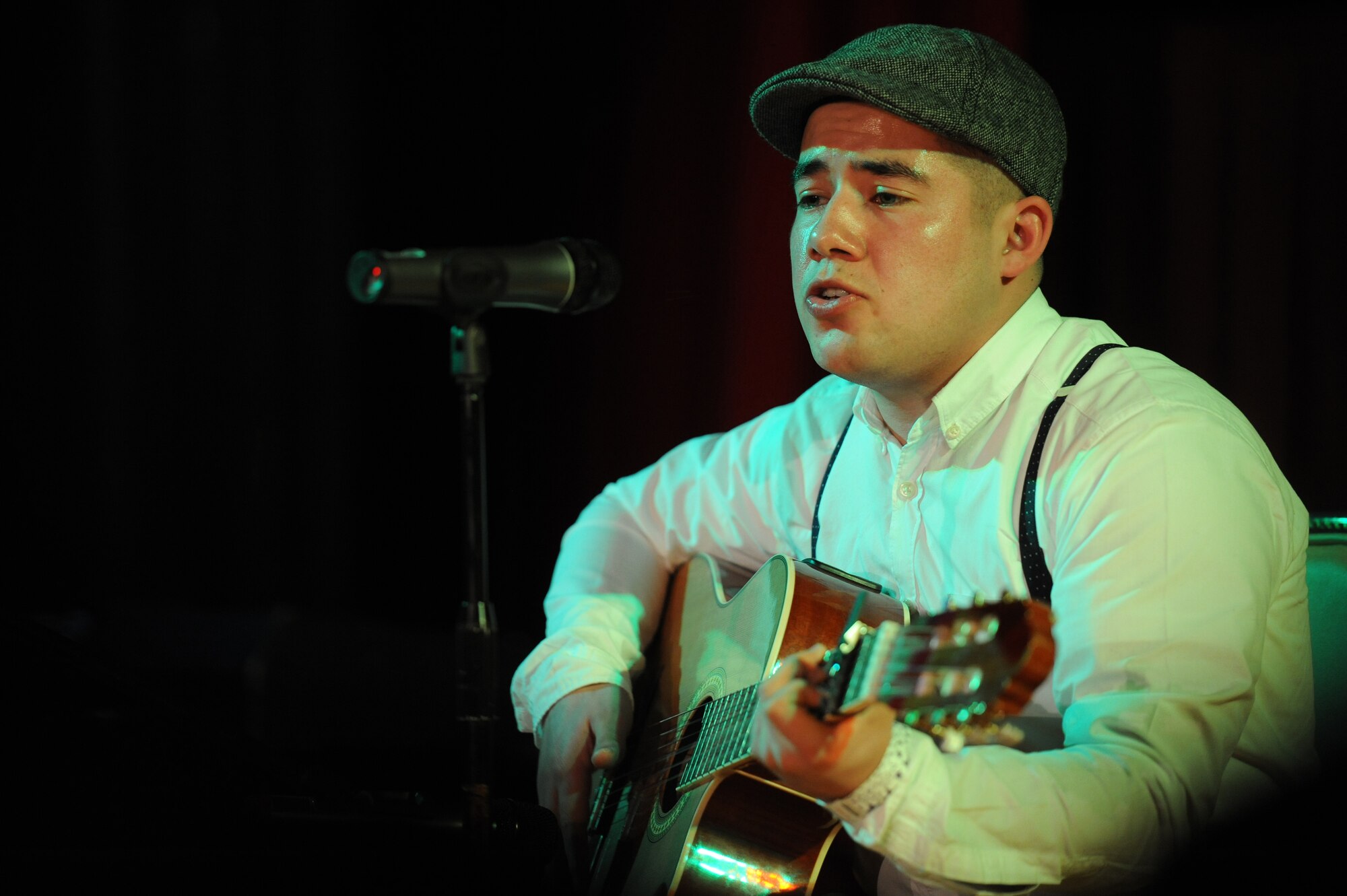 Airman 1st Class Jesus Garcia, 721st Aerial Port Squadron air transportation specialist, plays guitar and sings during Apollo Night at the Armstrong Club on Vogelweh Military Complex, Germany, Feb. 23, 2013. Apollo Night in the Kaiserslautern Military Community traces its roots to the original event in Harlem New York, and gives members of the KMC a chance to do something out of the ordinary. (U.S. Air Force photo/Senior Airman Aaron-Forrest Wainwright)
