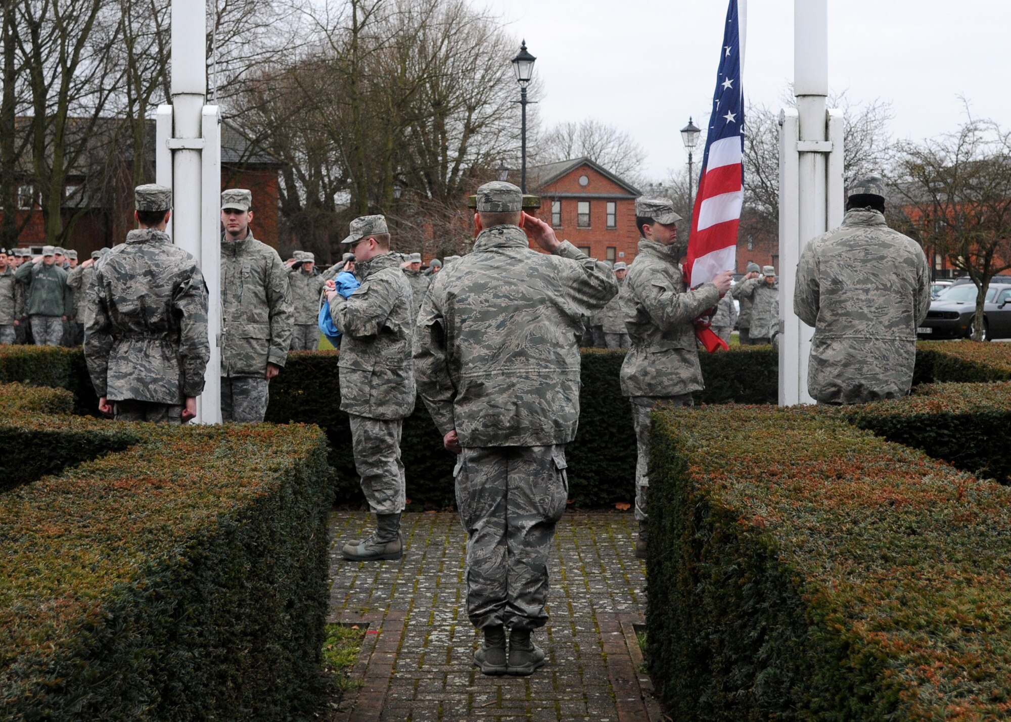 Airmen from the 100th Mission Support Group perform a retreat ceremony Feb. 22, 2013, RAF Mildenhall, England. Retreat is a ceremony symbolizing the end of the duty day whilst paying respect to the American and British flags. (U.S. Air Force photo by Airman 1st Class Kelsey Waters/Released)