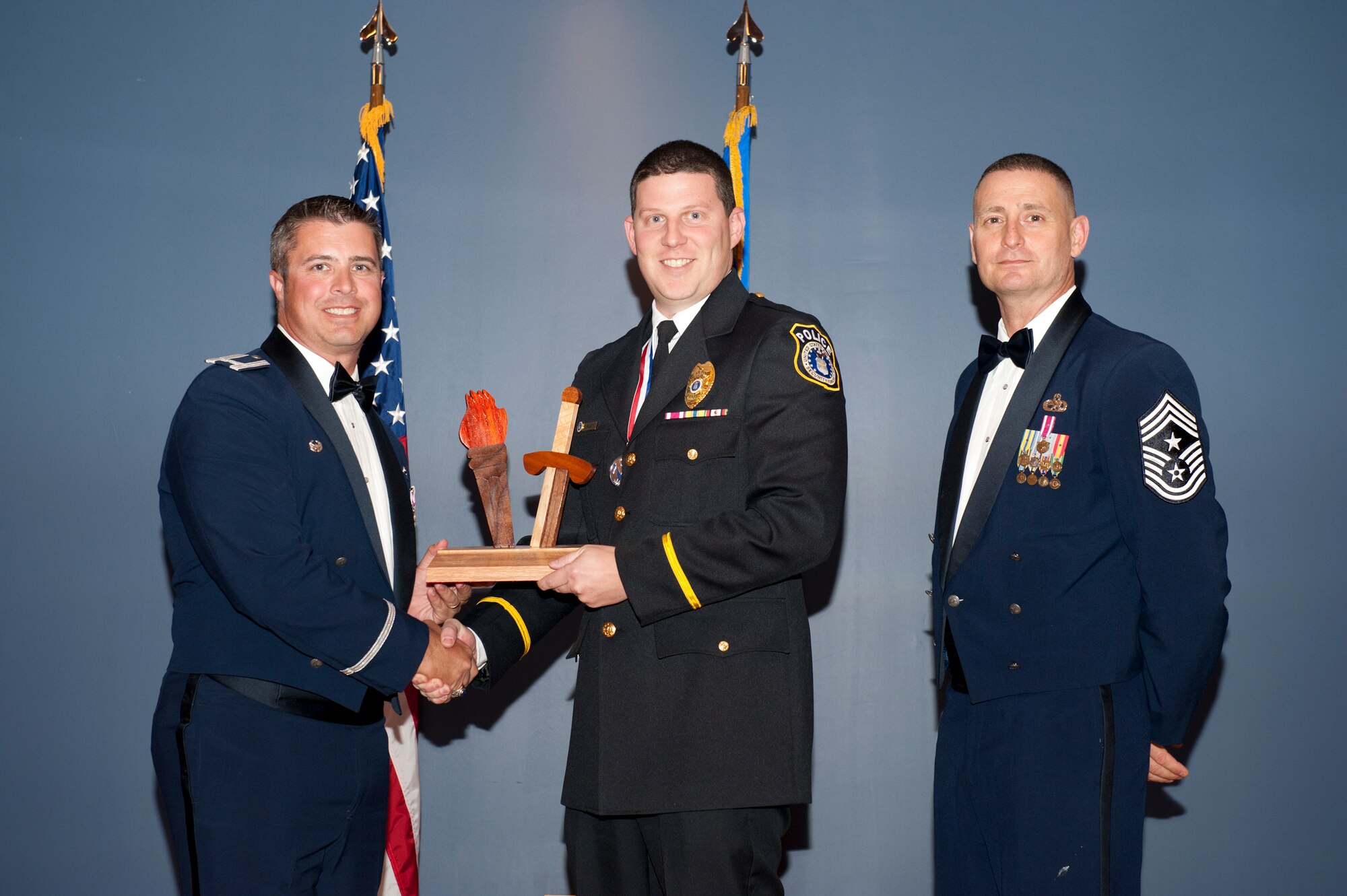 Mr. Michael Bernatt, 325th Security Forces Squadron, receives the 2012 Team Tyndall Annual Award for Category II Civilian of the Year Feb. 20 from Col. David Graff, 325th Fighter Wing commander and Chief Master Sgt. Ray DeVite, 325th FW command chief. (U.S. Air Force photo by Lisa Norman)