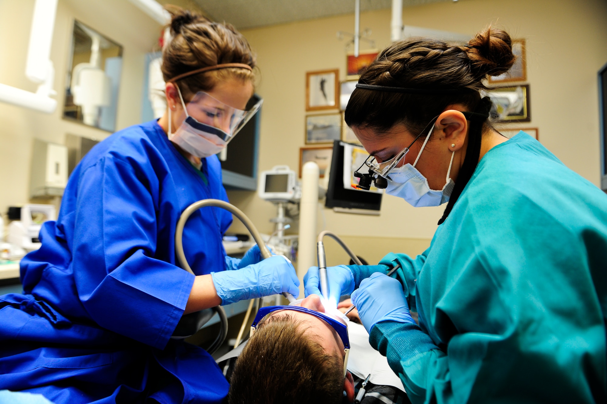 U.S. Air Force Capt. AnnMarie Moshos, a general dentist for 1st Special Operation Dental Squadron, and Airman 1st Class Misty Alcoriza, a dental assistant for 1st SODS, works on a patient at the Dental Clinic on Hurlburt Field, Fla., Feb. 20, 2013. If a dental issue is categorized as a class three-issue then that may hold you back from orders to deploy. (U.S. Air Force photo/Airman 1st Class Christopher Callaway) 