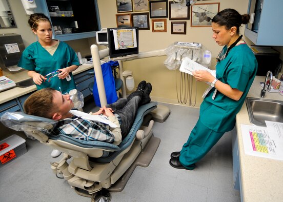 U.S. Air Force Capt. AnnMarie Moshos, a general dentist for 1st Special Operation Dental Squadron, goes over information with the patient before performing cavity procedures at the Dental Clinic on Hurlburt Field, Fla., Feb. 20, 2013.  Poor dental hygiene, such as impacted wisdom teeth or cavities, categorized as a class three-issue may get and Airman sent home or kept from a potential deployment. (U.S. Air Force photo/Airman 1st Class Christopher Callaway)