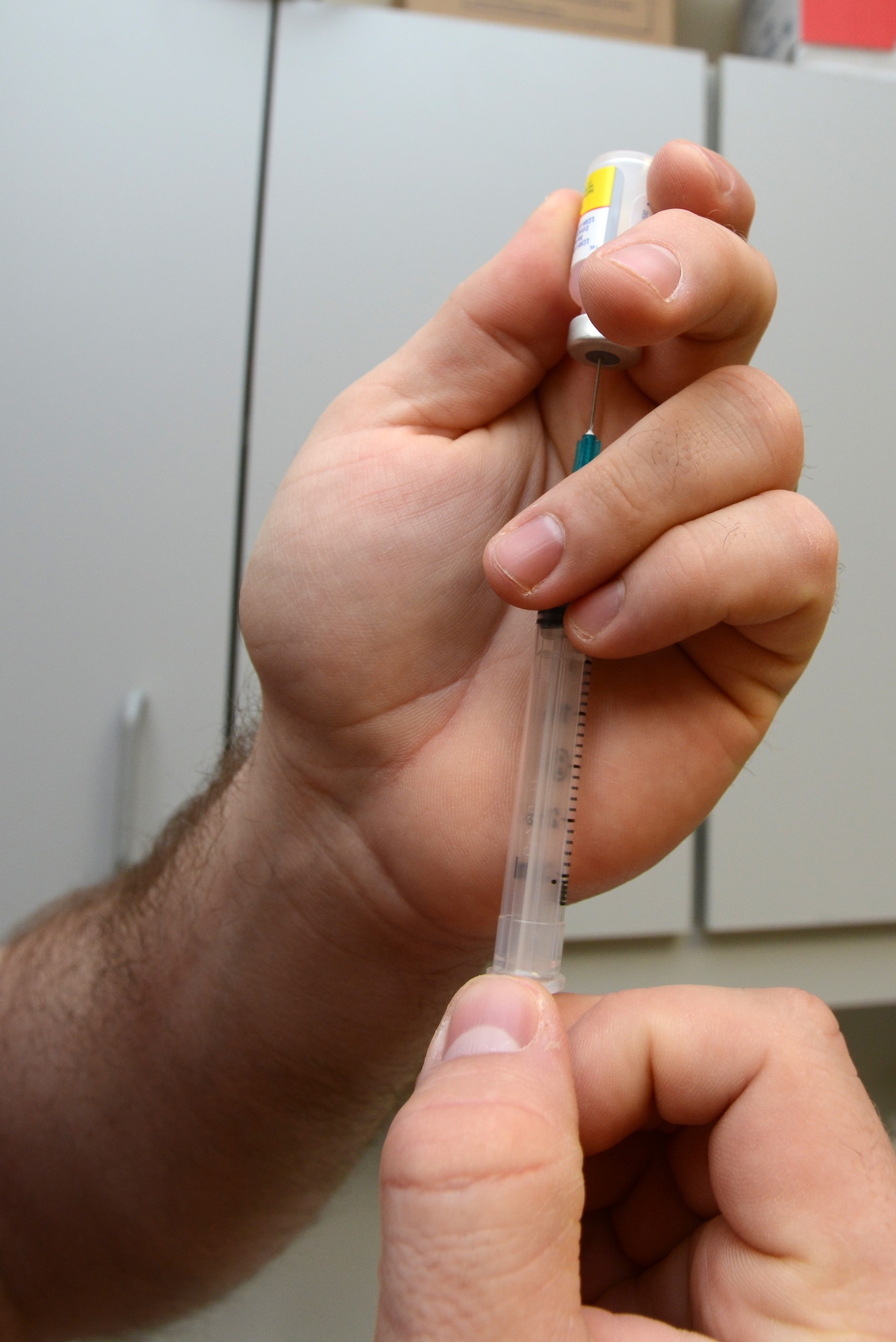 Jeremiah Berg, 39th Medical Group veterinary health technician, prepares a vaccination at the Veterinary Clinic, Feb. 22, 2013, at Incirlik Air Base, Turkey.  The primary mission of the Veterinary Clinic is to provide medical care to military working dogs, however, the facility offers care to privately owned pets by appointment. (U.S. Air Force photo by Tech. Sgt. Dallas Edwards/Released)