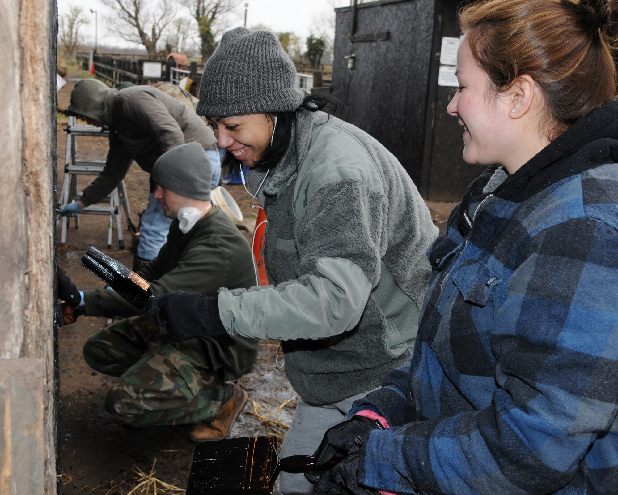 Airmen from the 100th Logistics Readiness Squadron paint animal stalls at the Isleham Horse and Pony Rescue Center at Willow Tree Stables Feb. 22, 2013, at Isleham, England. Airmen from the 100th LRS volunteered at the shelter, which rescues animals such as horses, rabbits, donkeys and goats. (U.S. Air Force photo by Airman 1st Class Kelsey Waters/Released)