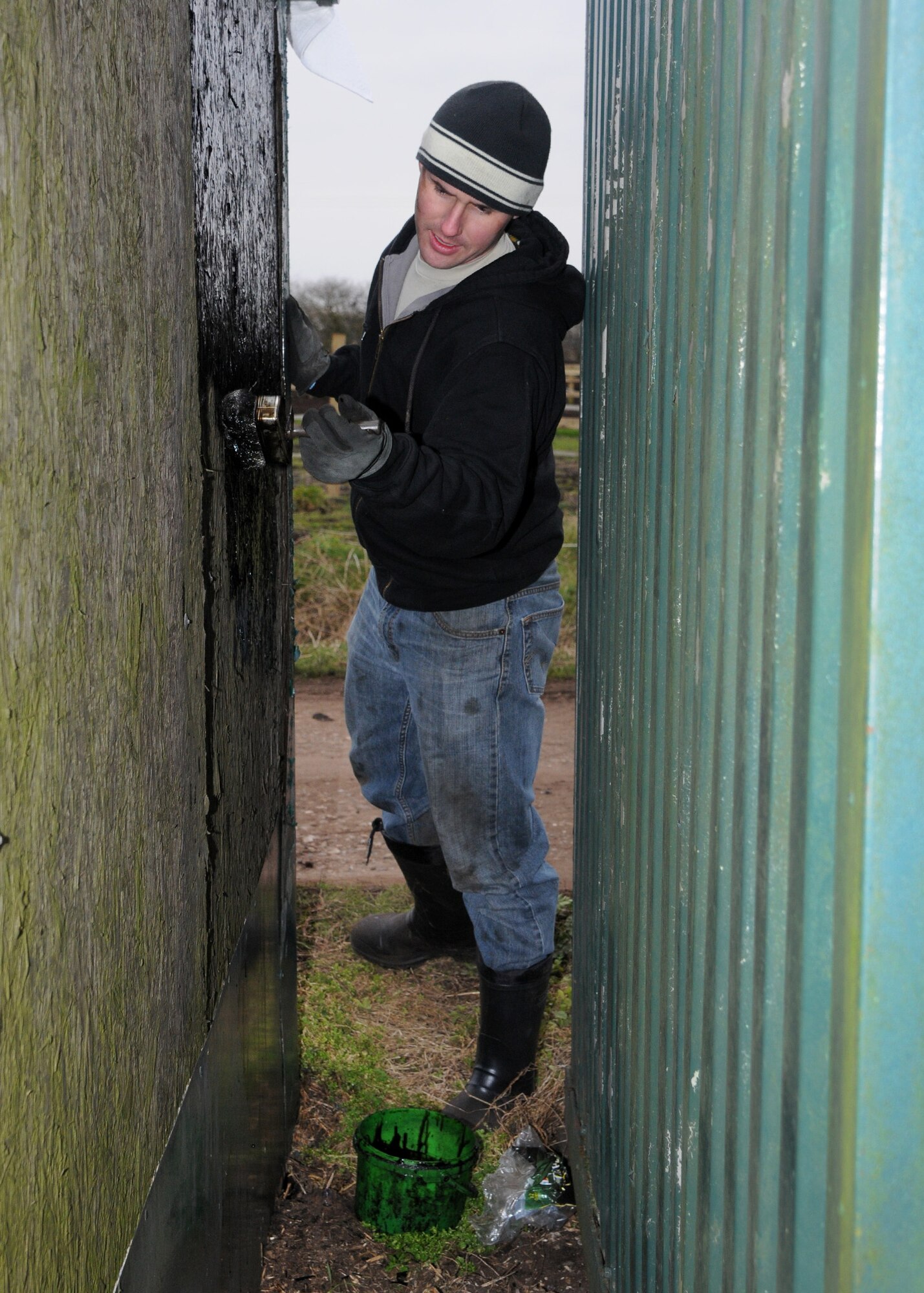 Staff Sgt. Kevin Searls, 100th Logistics Readiness Squadron Fuels Service Center controller from Houston, paints an animal stall at the Isleham Horse and Pony Rescue Center at Willow Tree Stables Feb. 22, 2013, at Isleham, England. Airmen from the 100th LRS volunteered at the shelter, which rescues animals such as horses, rabbits, donkeys and goats. (U.S. Air Force photo by Airman 1st Class Kelsey Waters/Released)