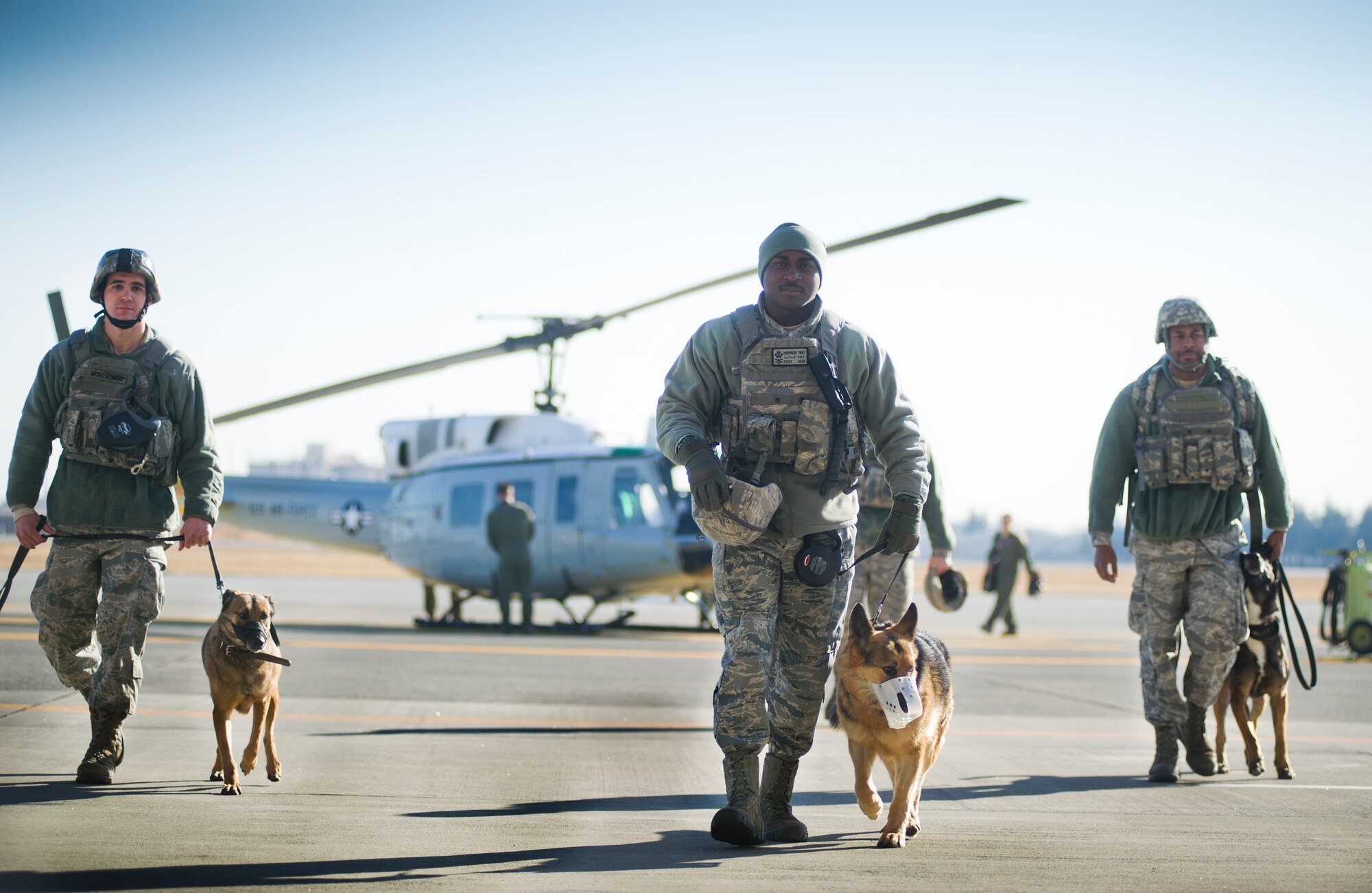 YOKOTA AIR BASE, Japan -- Military working dog handlers from the 374th Security Force Squadron walk away from a UH-1N Huey helicopter during fly-away security team training at Yokota Air Base, Japan, Feb. 25, 2013. The real work of the FAST security team members comes when their aircraft lands. From there, the team must stay vigilant until the mission is complete. (U.S. Air Force photo by Staff Sgt. Stacy Moless)