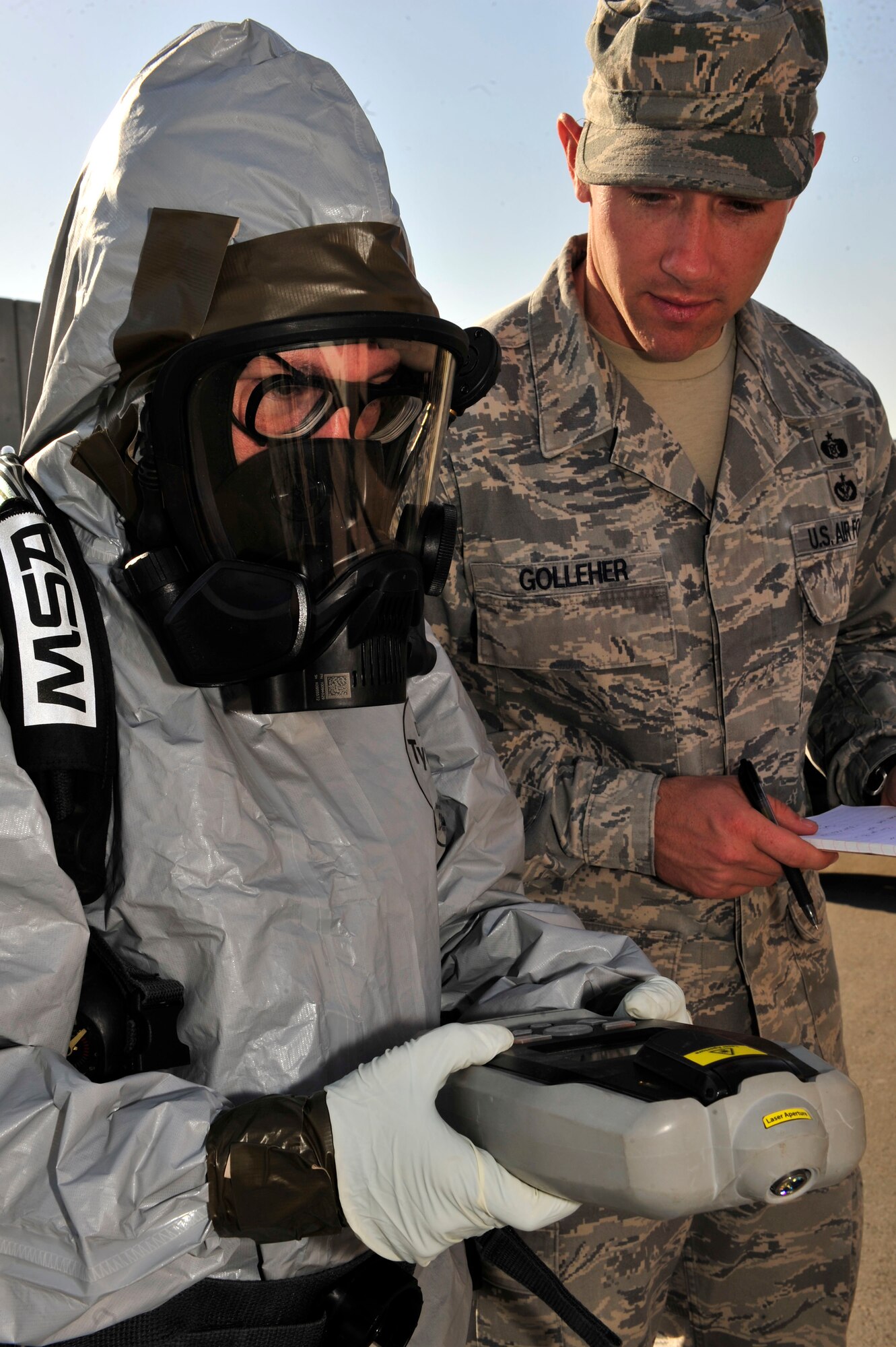 U.S. Air Force Staff Sgt. Shoshana Claes, 380th Expeditionary Civil Engineer Squadron emergency management programs, uses an Ahura First Defender hazardous material identifier to test suspicious materials while being evaluated by Staff Sgt. Randy Golleher, 380 ECES emergency management training NCOIC, during a chemical, biological, radiological, nuclear and explosives (CBRNE) response exercise at an undisclosed location in Southwest Asia Feb. 15, 2013. The emergency management office participates in monthly exercises to ensure they are ready in the case of a real-world scenario. Claes is deployed from Barksdale Air Force Base, La. and Golleher is deployed from Nellis AFB, Nev. (U.S. Air Force photo by Tech. Sgt. Christina M. Styer/Released)