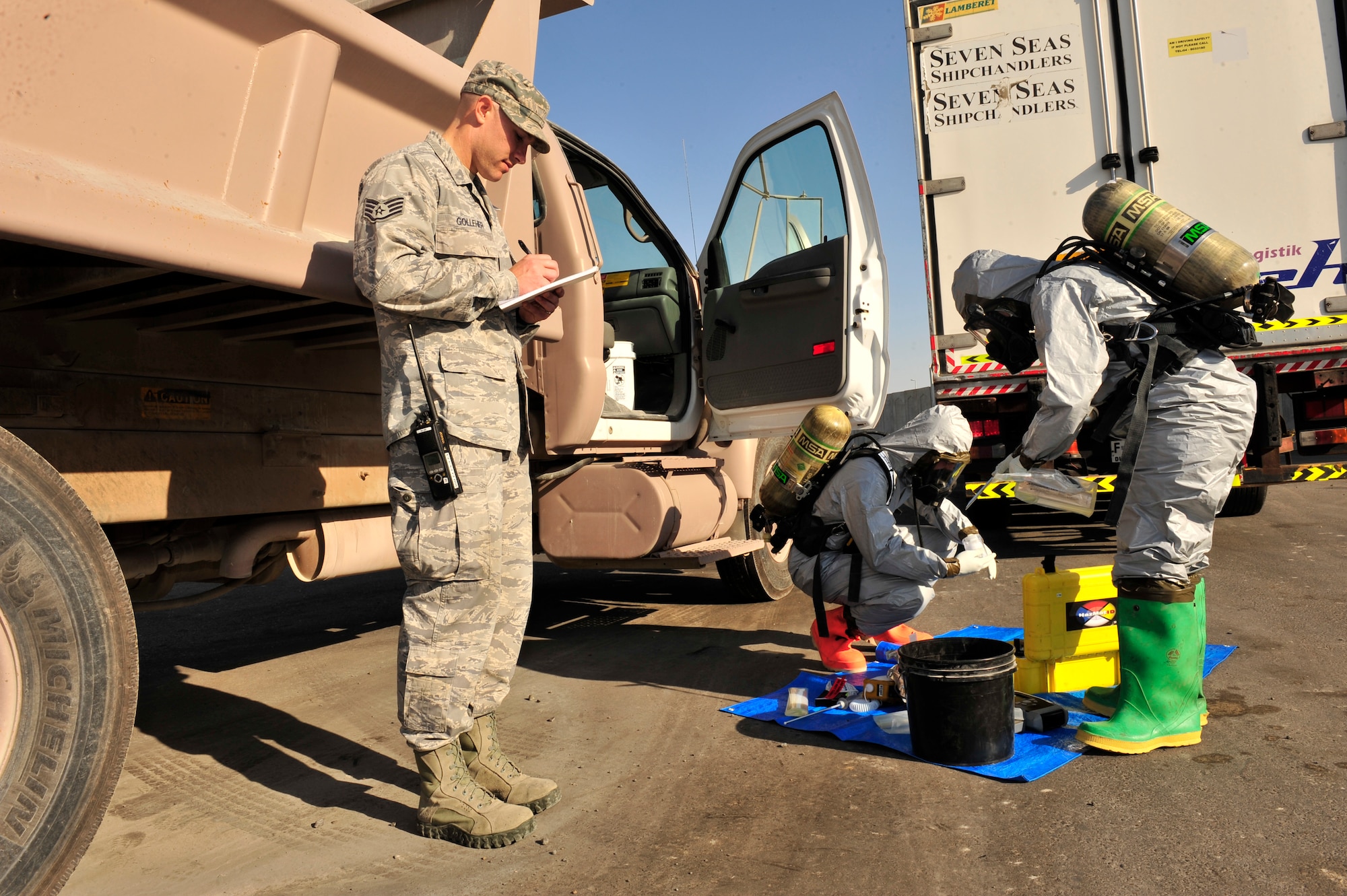 U.S. Air Force Staff Sgt.Randy Golleher, 380th Expeditionary Civil Engineer Squadron emergency management training NCOIC, evaluates as Staff Sgt. Shoshana Claes, 380 ECES emergency management programs, and Senior Airman Jacob Allen, 380 ECES emergency management journeyman, test suspicious materials during a chemical, biological, radiological, nuclear and explosives (CBRNE) response exercise at an undisclosed location in Southwest Asia Feb. 15, 2013. The emergency management office participates in monthly exercises to ensure they are ready in the case of a real-world scenario. Golleher is deployed from Nellis Air Force Base, Nev., Claes is deployed from Barksdale AFB, La. and Allen is deployed from Eielson AFB, Alaska. (U.S. Air Force photo by Tech. Sgt. Christina M. Styer/Released)