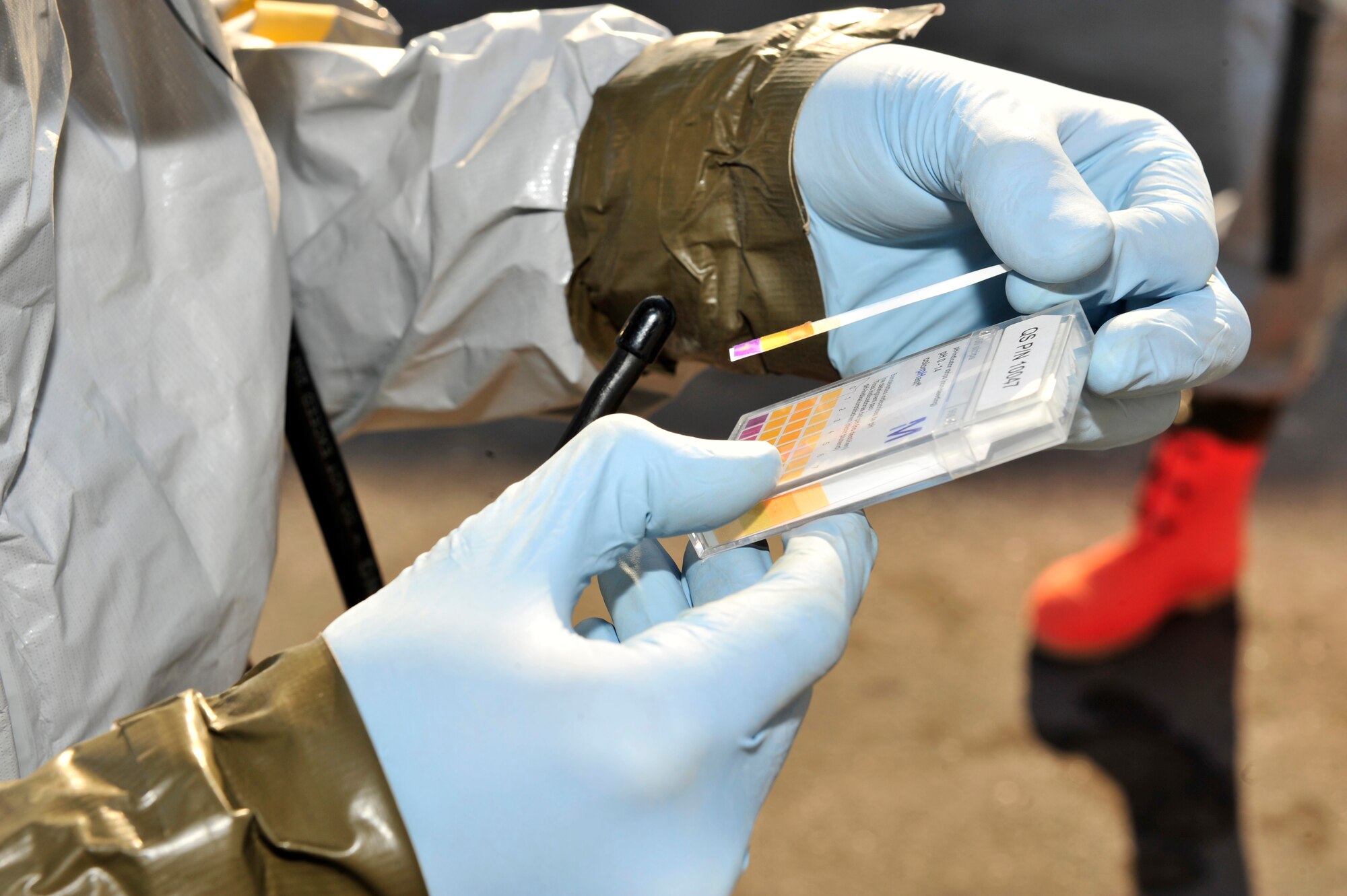 U.S. Air Force Staff Sgt. Jordon Stipcak, 380th Expeditionary Civil Engineer Squadron emergency management craftsman, uses pH paper to test suspicious materials during a chemical, biological, radiological, nuclear and explosives (CBRNE) response exercise at an undisclosed location in Southwest Asia Feb. 15, 2013. The emergency management office participates in monthly exercises to ensure they are ready in the case of a real-world scenario. Stipcak is deployed from Kadena Air Base, Japan. (U.S. Air Force photo by Tech. Sgt. Christina M. Styer/Released)