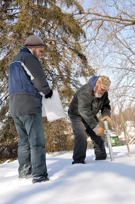 CANNON FALLS, Minn. -- Shahin Khazrajarari, left, Corps of Engineers, St. Paul District project manager, and Farley Haase, Corps of Engineers, St. Paul District survey technician, conduct snow surveys near the Cannon River in Cannon Falls, Minn., Feb 28, 2011. 