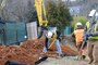 Crews use a magnetometer to investigate a test pit at 4825 Glenbrook Road.  