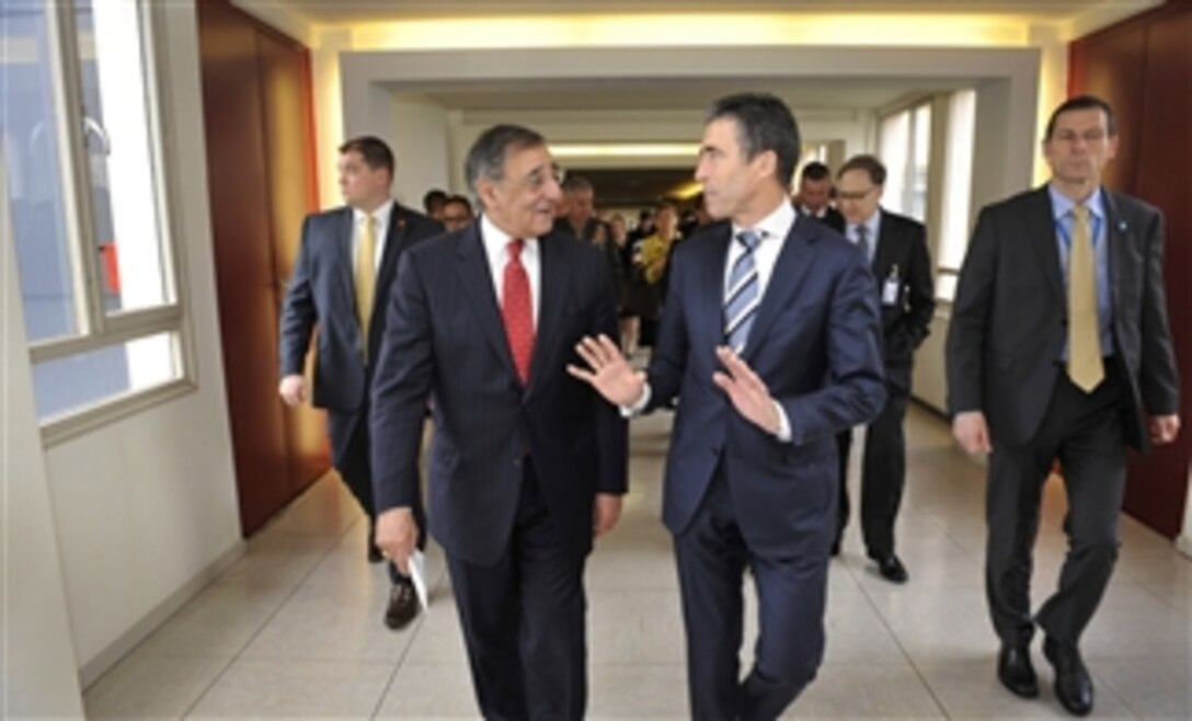 Secretary of Defense Leon E. Panetta, left, listens to NATO Secretary General Anders Fogh Rasmussen, right, as they walk to lunch at NATO headquarters in Brussels, Belgium, on Feb. 21, 2013.  Both men are attending the NATO Defense Ministerial meetings in Brussels.  The current International Security Assistance Force mission and the follow-on NATO mission in Afghanistan are the central topic of group meetings and Panetta’s own one-on-one discussions with allied and partner ministers here this week.  