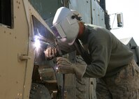 HADITHAH, Al Anbar, Iraq- 25 year old  Vermilion,Ohio native, Cpl. Jeffrey A. Thayer, a vehicle operator with 3/25, begins work on a HMMV needing more armor in the continuing effort to combat terrorism.