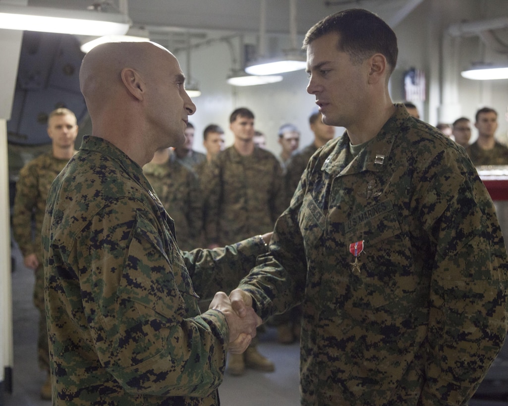 Capt. John E. Nobles III, Force Reconnaissance platoon commander, 26th Marine Expeditionary Unit, is awarded the Bronze Star Medal with combat distinguishing device aboard the USS Kearsarge by Col. Matthew G. St. Clair, 26th MEU commanding officer, while at sea, Feb. 16, 2013. He was awarded the medal for performing selfless acts of valor in the Upper Sangin River Valley, Jan. 8, 2011 to June 7, 2011, 