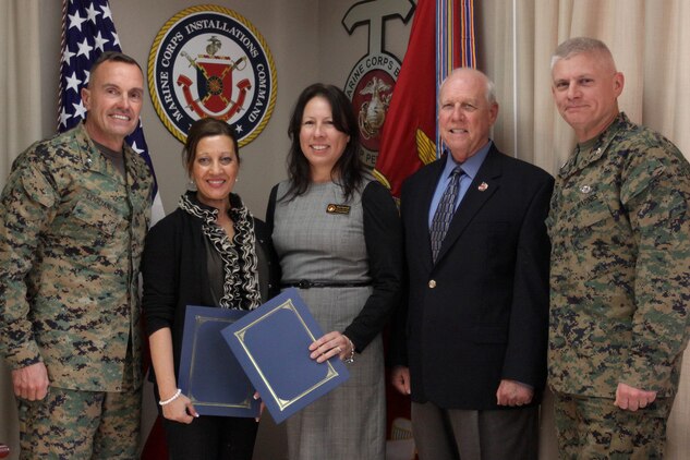 Brig. Gen. Vincent A. Coglianese, left, retired Lt. Col. Larry Rannals, center-right, and Col. Eugene Apicella, right, presented Maria Swanson, center-left, and Rose Ingersoll, center,  with letters of appreciation at the Marine Corps Installations Commanding General’s Office here, Feb. 25.
