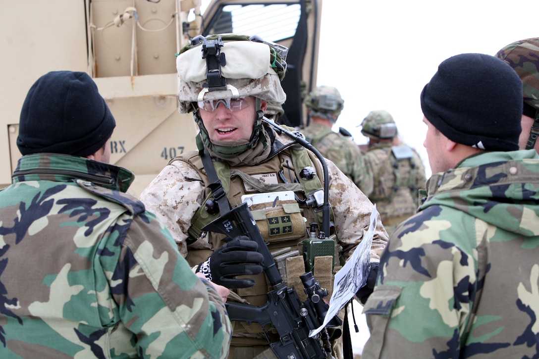 Marine Capt. Brian Hart, officer-in-charge of the Georgia Liaison Team attached with the Republic of Georgia's 42nd Light Infantry Battalion, Bravo Co., gives a few pointers a to some of the Bravo Co. leaders during an out-of-sector battalion clearance operation outside a training village aboard Joint Multinational Readiness Center Hohenfels, Germany, Feb. 14. Captain Hart has been mentoring and advising the Georgian soldiers for more than five months. He is a native of Brooklyn, N.Y. The Mission Rehearsal Exercise is the culminating event for the Republic of Georgia's 33rd and 42nd Light Infantry Battalion prior to deploying to Afghanistan to conduct security operations in support of the Georgia Deployment Program - International Security Assistance Force (GDP-ISAF). The total training exercise ran from Jan. 22 - Feb 22.