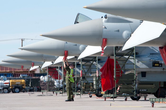 A Royal Air Force Coningsby No.11 Squadron crew chief removes a pitot tube cover during a pre-flight inspection on a Typhoon during Red Flag 13-3 Feb. 25, 2013, at Nellis Air Force Base, Nev. The RAF Typhoon aircraft is participating in Red Flag for the first time. (U.S. Air Force photo by Lawrence Crespo)