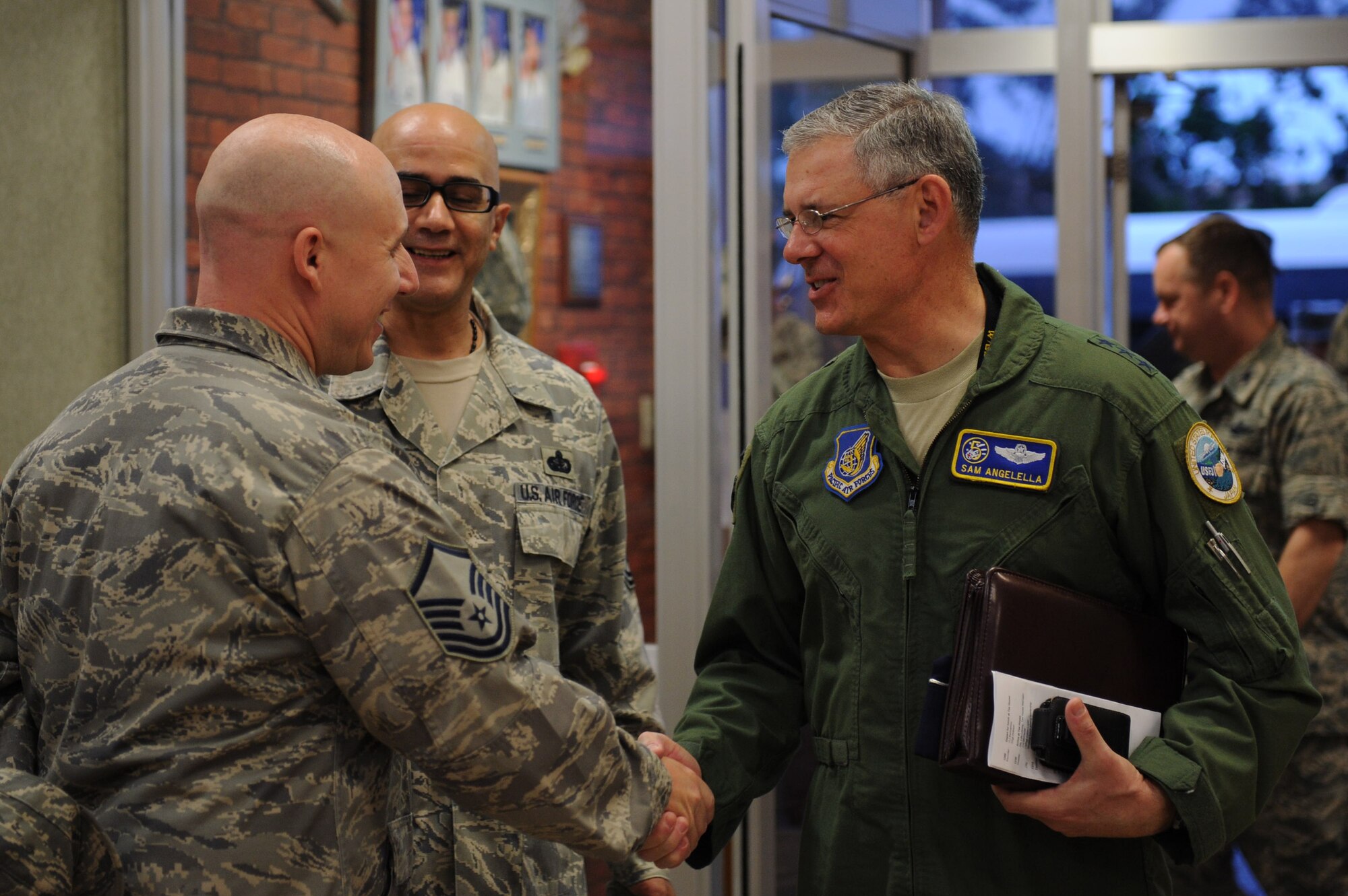 U.S. Air Force Lt. Gen. Sam Angelella, U.S. Forces, Japan, and 5th Air Force commander, greets Master Sgt. Michael Fogle, 18th Force Support Squadron food service section chief, at the Marshall Dining Facility on Kadena Air Base, Japan, Feb. 26, 2013. Angelella also held an all-call where he coined Pacific Air Forces award winners and touched on various topics including curfew guidelines and sequestration. (U.S. Air Force photo/Airman 1st Class Hailey R. Davis)