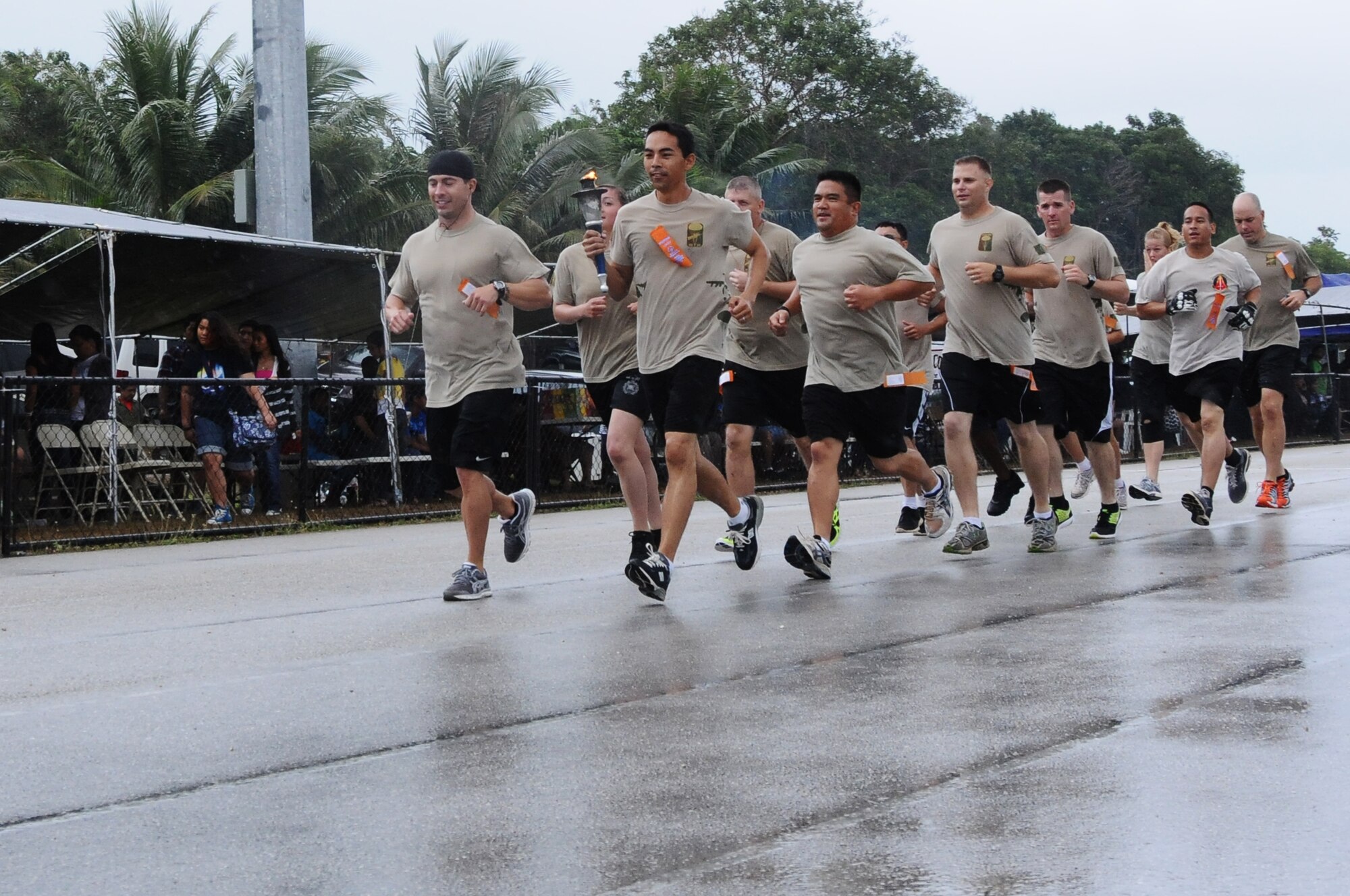 Members of the 736th Security Forces Squadron carry the torch during the opening ceremonies of the Special Olympics of Guam, March 17, 2012. The 736th Security Force Squadron won the Pacific Air Forces Outstanding Small Security Forces Unit Award for 2012.  (U.S. Air Force photo/Senior Airman Carlin Leslie)