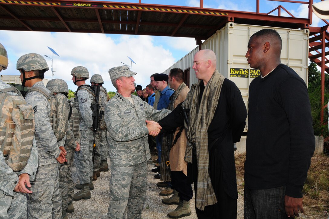 Gen. Herbert “Hawk” Carlisle, Pacific Air Forces commander, shakes hands with Master Sgt. Joseph Crow, 736th Security Forces Squadron standardization and evaluation NCO in charge, after a counter-improvised explosive device training demonstration at Northwest Field, Guam, Dec. 3, 2012. Airmen from the 736th SFS donned their gear while others dressed up as opposing forces to present the general with different training capabilities that Andersen Air Force Base offers to the Asia-Pacific region. (U.S. Air Force photo by Airman 1st Class Marianique Santos/Released)
