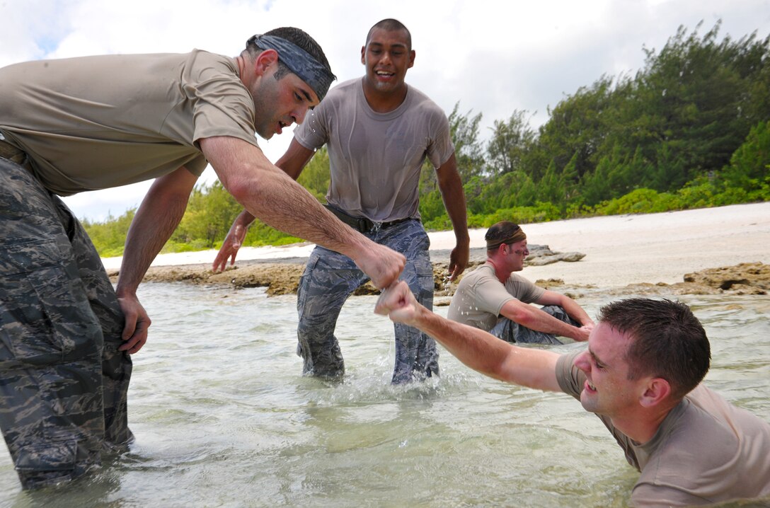 Members of the 736th Security Forces Squadron congratulate each other after recording the most repetitions in the “Team Pain” event of the warrior challenge May 16, 2012. The 736th Security Force Squadron won the Pacific Air Forces Outstanding Small Security Forces Unit Award for 2012.  (U.S. Air Force photo by Senior Airman Benjamin Wiseman/Released