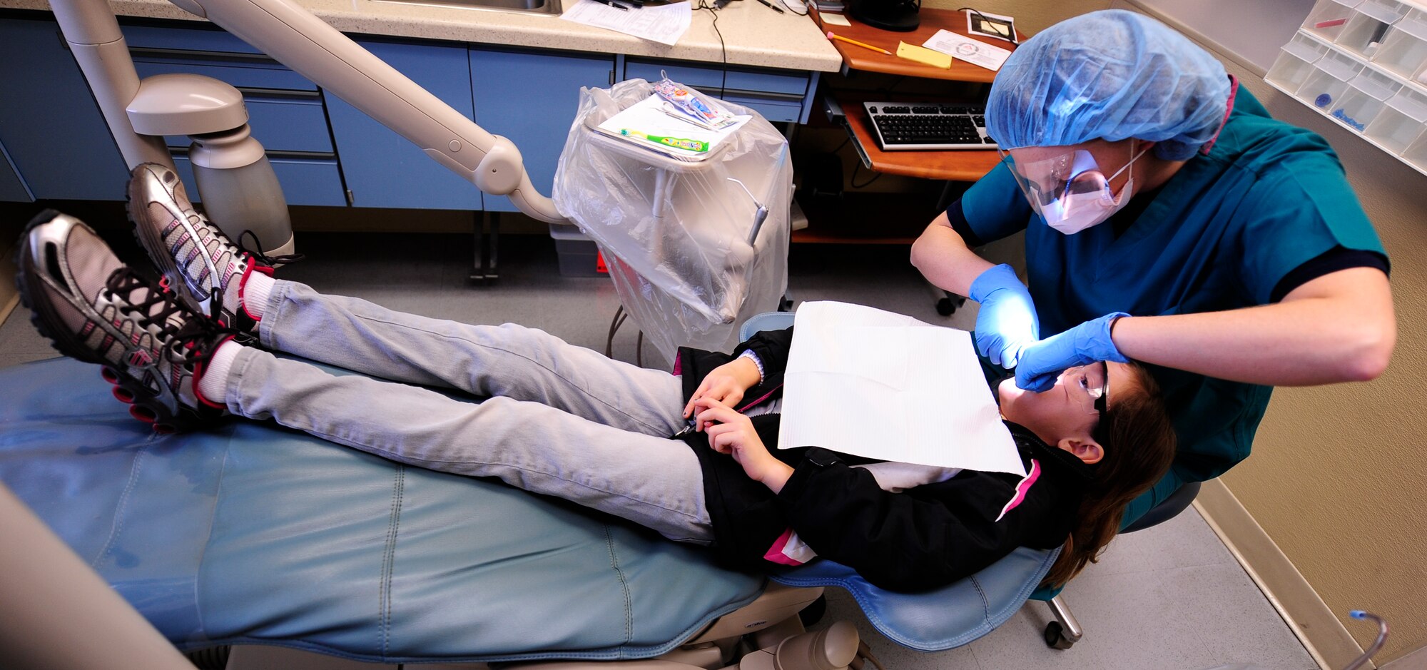 Kristina Stephens, age 9,waits patiently while a dentist from the 1st Special Operations Dental Squadron, checks her teeth during 'Little Teeth, Big Smiles' Kids Clinic on Hurlburt Field, Fla., Feb. 23, 2013. According to Stephens, she really enjoyed the experience because the doctors were nice and one dressed like the tooth fairy. (U.S. Air Force photo/Senior Airman Kentavist Brackin)
