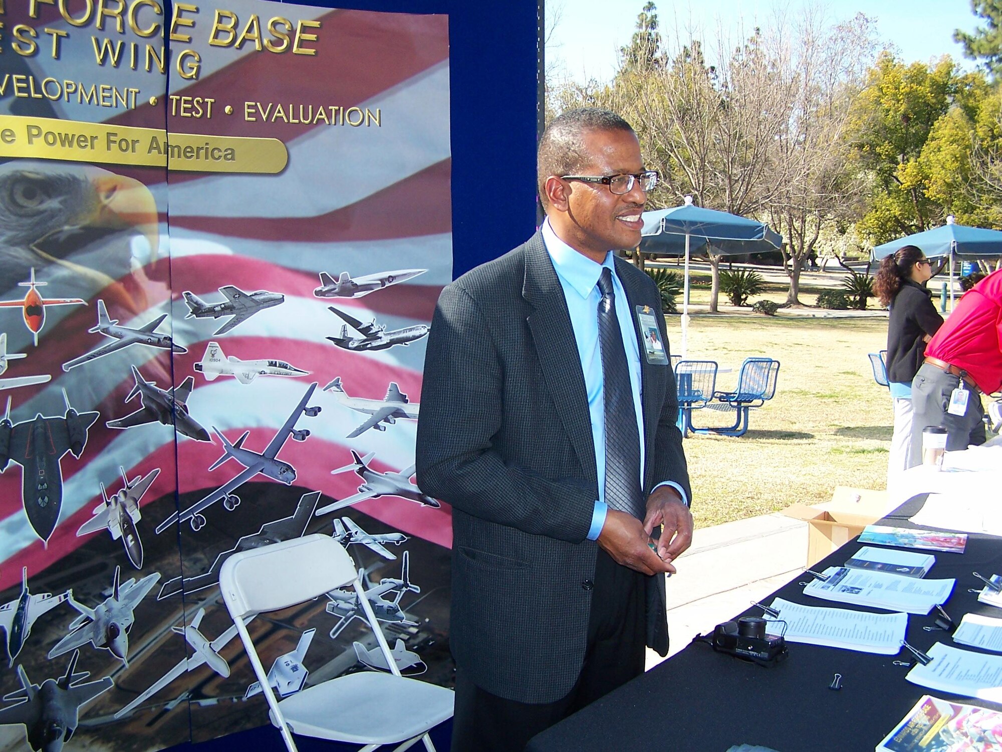 Mickey Bowen, 412th Test Wing, stands in front of the Edwards Air Force Base information booth at the 13th Annual Engineers Day event Feb. 22. The event was part of the base's Science, Technology, Engineering and Mathematics initiative. (Courtesy photo)