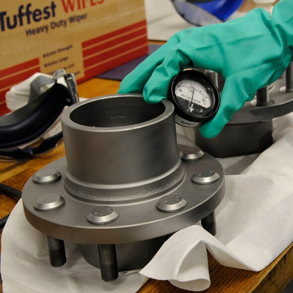 Senior Airman Brian Burkett, 2nd Maintenance Squadron Non-Destructive Inspection, uses a field indicator during a magnetic particle inspection on Barksdale Air Force Base, La., Feb. 26. Field indicators are used to determine whether the part is magnetized. If the part is magnetized, magnetic particles will stick to the metal during the inspection. (U.S. Air Force photo/Airman 1st Class Andrew Moua)