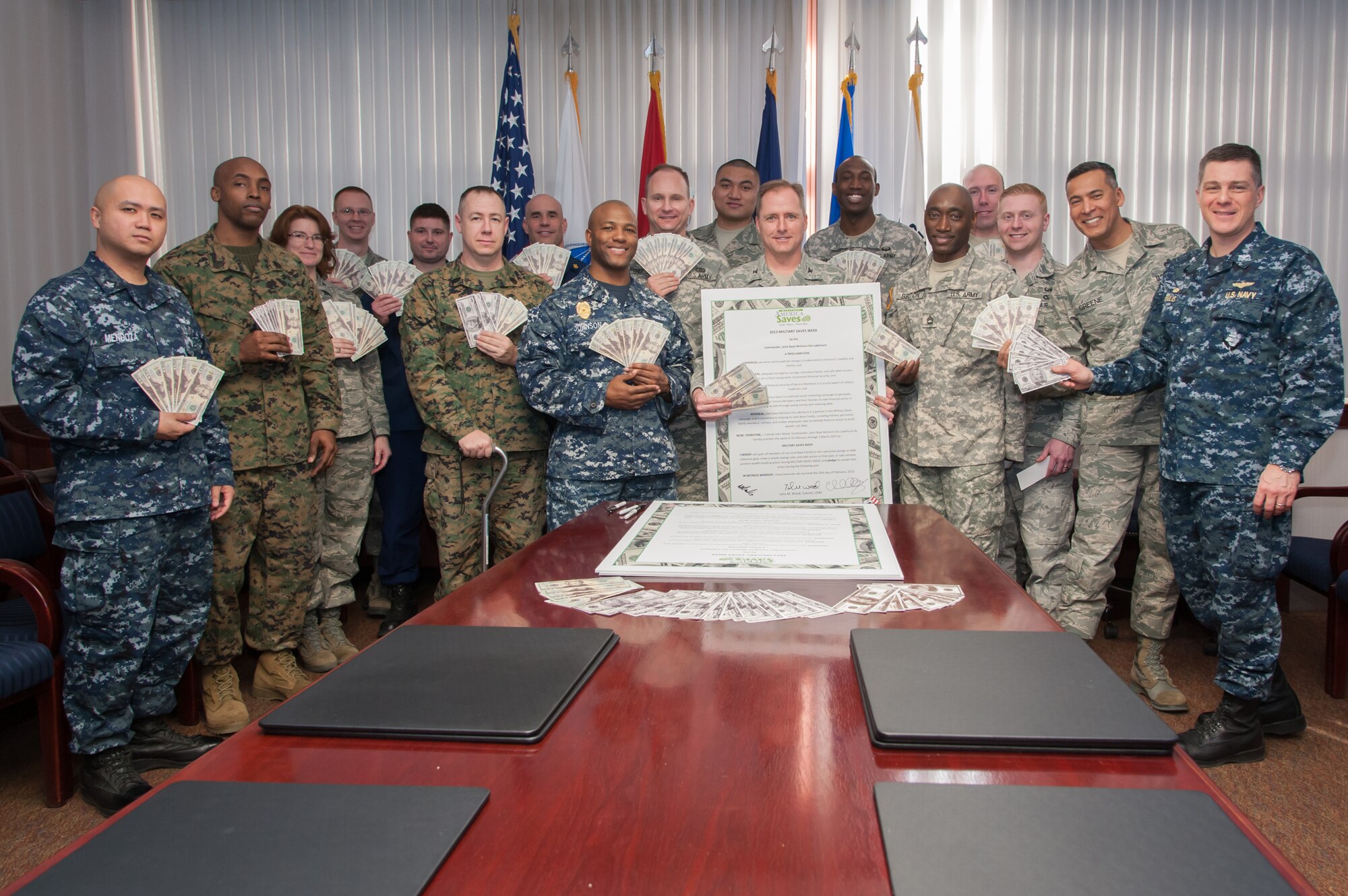 Col. John Wood, Joint Base McGuire-Dix-Lakehurst commander, and representatives from every service started the Military Saves Week campaign with a proclamation signing Feb. 25, 2013, at Joint Base McGuire-Dix-Lakehurst, N.J.  Military Saves Week is a national campaign geared toward motivating and encouraging military families to save money monthly and convincing leaders and organizations to promote automatic savings programs. (U.S. Air Force photo by Russell Meseroll/Released)