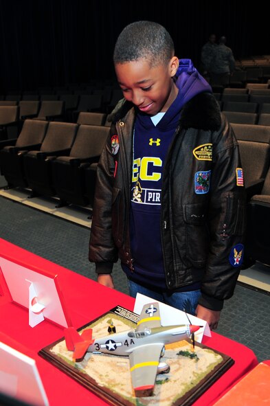 Jacob McMillan, son of Chief Master Sgt. Stevie McMillan, 4th Civil Engineer Squadron superintendant, admires a Tuskegee Airmen display after the 4th Fighter Wing Leadership Lecture Series: Perseverance through Adversity on Seymour Johnson Air Force Base, N.C., Feb. 22, 2013. The lecture was intended to teach Airmen about leaders and warriors in American history. (U.S. Air Force photo/Airman 1st Class Aubrey White/Released)