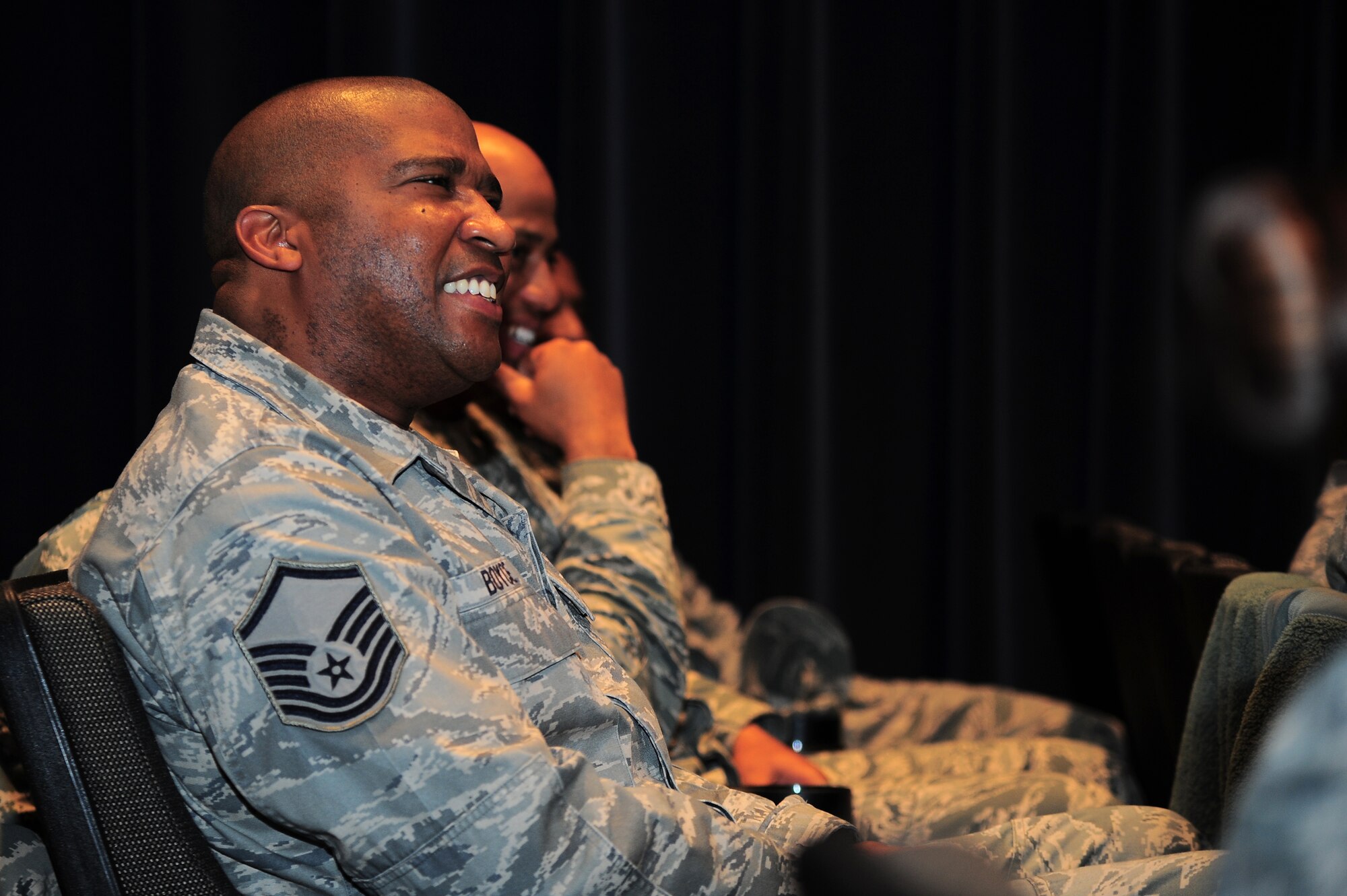 U.S. Air Force Master Sgt. Marques Boyce, 4th Logistics Readiness Squadron petroleum, oil and lubricants operations section chief, laughs during the 4th Fighter Wing Leadership Lecture Series: Perseverance through Adversity, on Seymour Johnson Air Force Base, N.C., Feb. 22, 2013. Several members of Team Seymour came out to hear about the history of the Tuskegee Airmen. (U.S. Air Force photo/Airman 1st Class Aubrey White/Released)