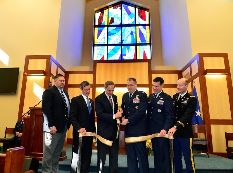 U.S. Sen. Tom Carper of Delaware, center left, and Col. Rick Moore, 436th Airlift Wing commander, cut the ribbon during the grand opening of the new base chapel Feb. 25, 2013, at Dover Air Force Base, Del. The new chapel replaces the old chapel that was built in 1956. (U.S. Air Force photo/David Tucker)