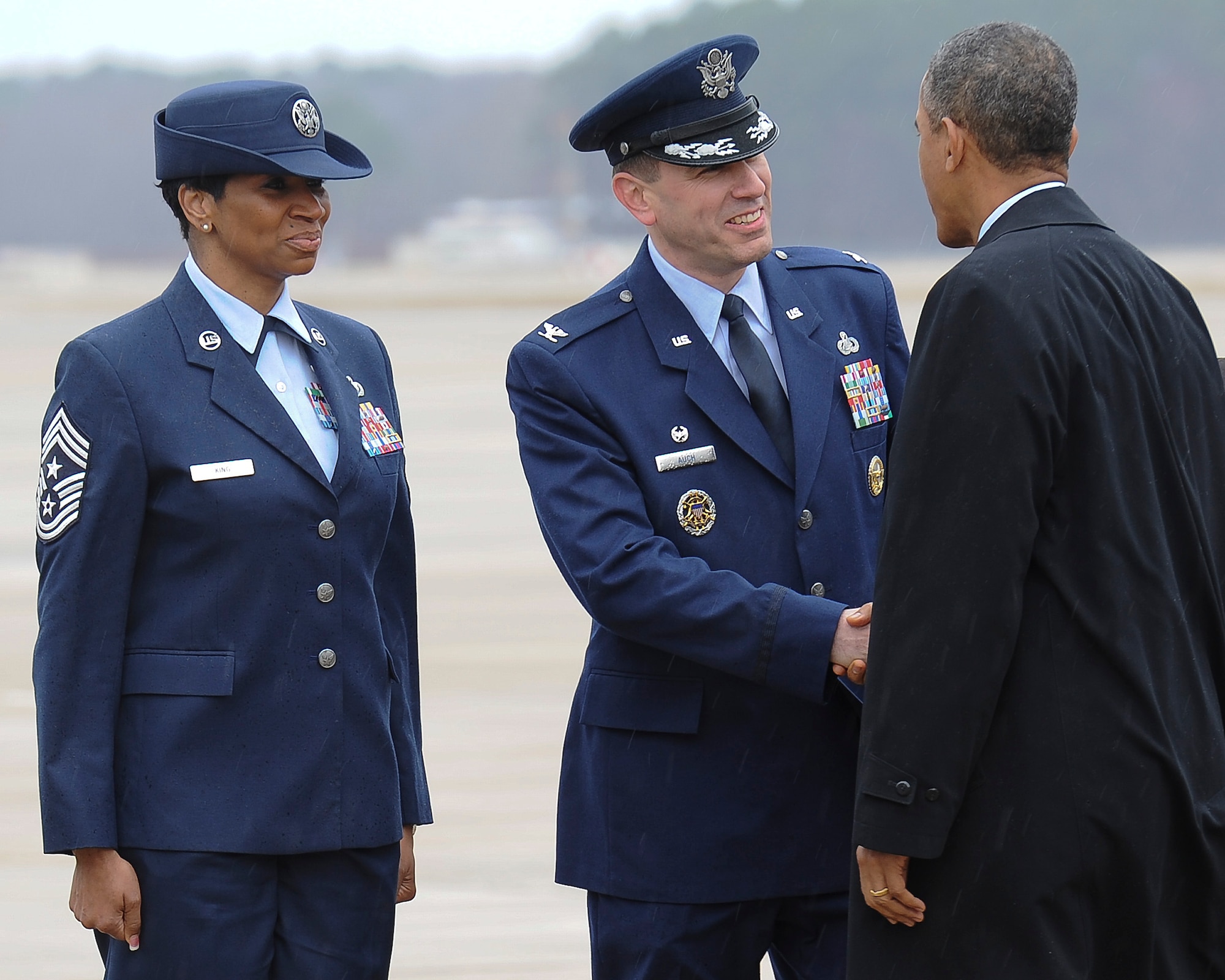 U.S. Air Force Col. Korvin Auch, 633rd Air Base Wing commander and Chief Master Sgt. Trae King, 633rd Air Base Wing command chief, greet President Barack Obama at Langley Air Force Base, Va., Feb. 26, 2013. The president was visiting Virginia to speak at a shipyard in Newport News about budget concerns and sequestration. (U.S. Air Force photo by Staff Sgt. Ciara Wymbs/Released)