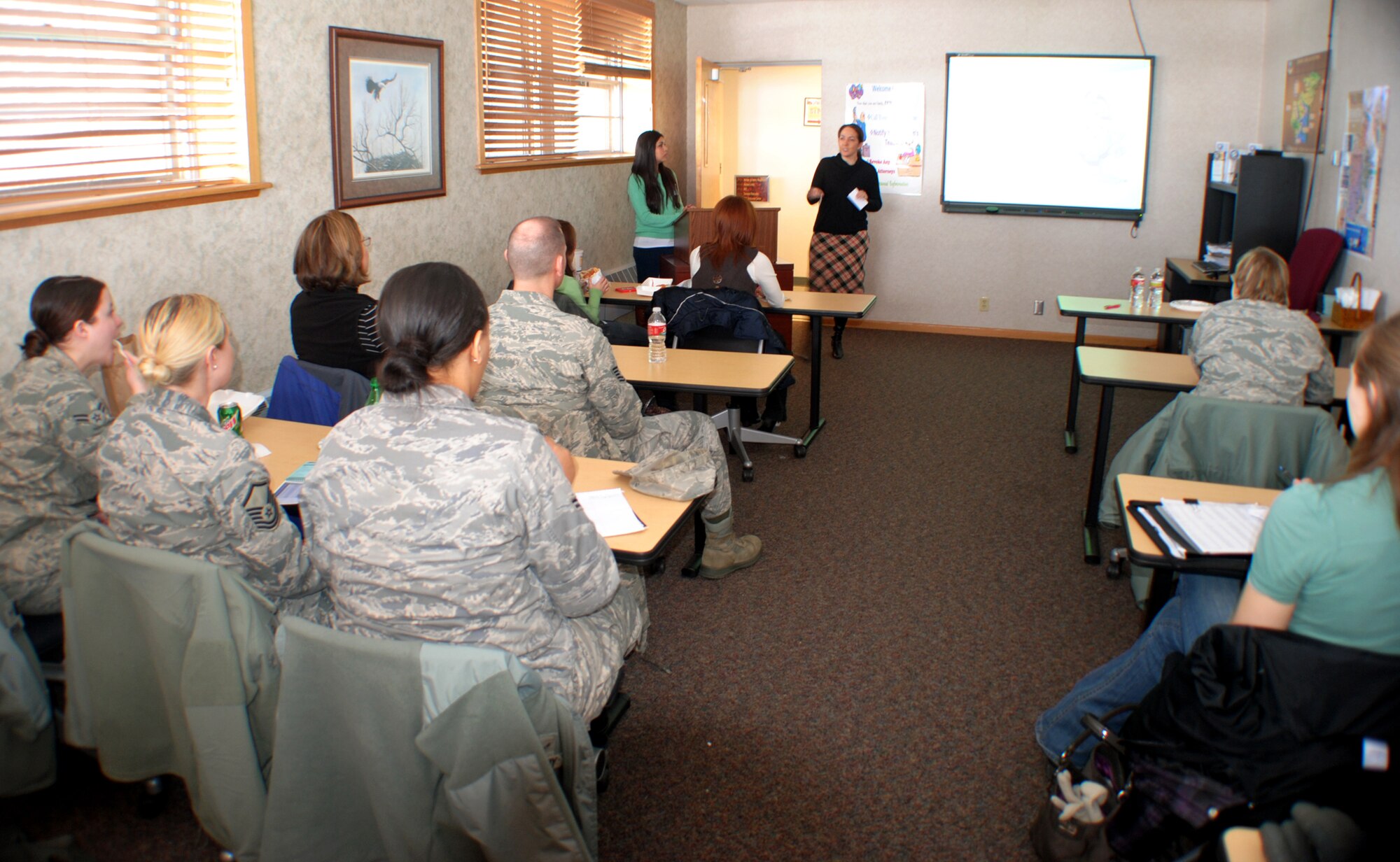 Jennifer Hemphill, an accredited financial counselor, welcomes military and civilian guests to the 2013 Lunch & Learn Financial Class on Feb. 22, 2013, at the Airman & Family Readiness Center on Grand Forks Air Force Base, N.D. The class was part of a series of events for this year’s Military Saves Week campaign. (U.S. Air Force photo/Senior Airman Luis Loza Gutierrez)