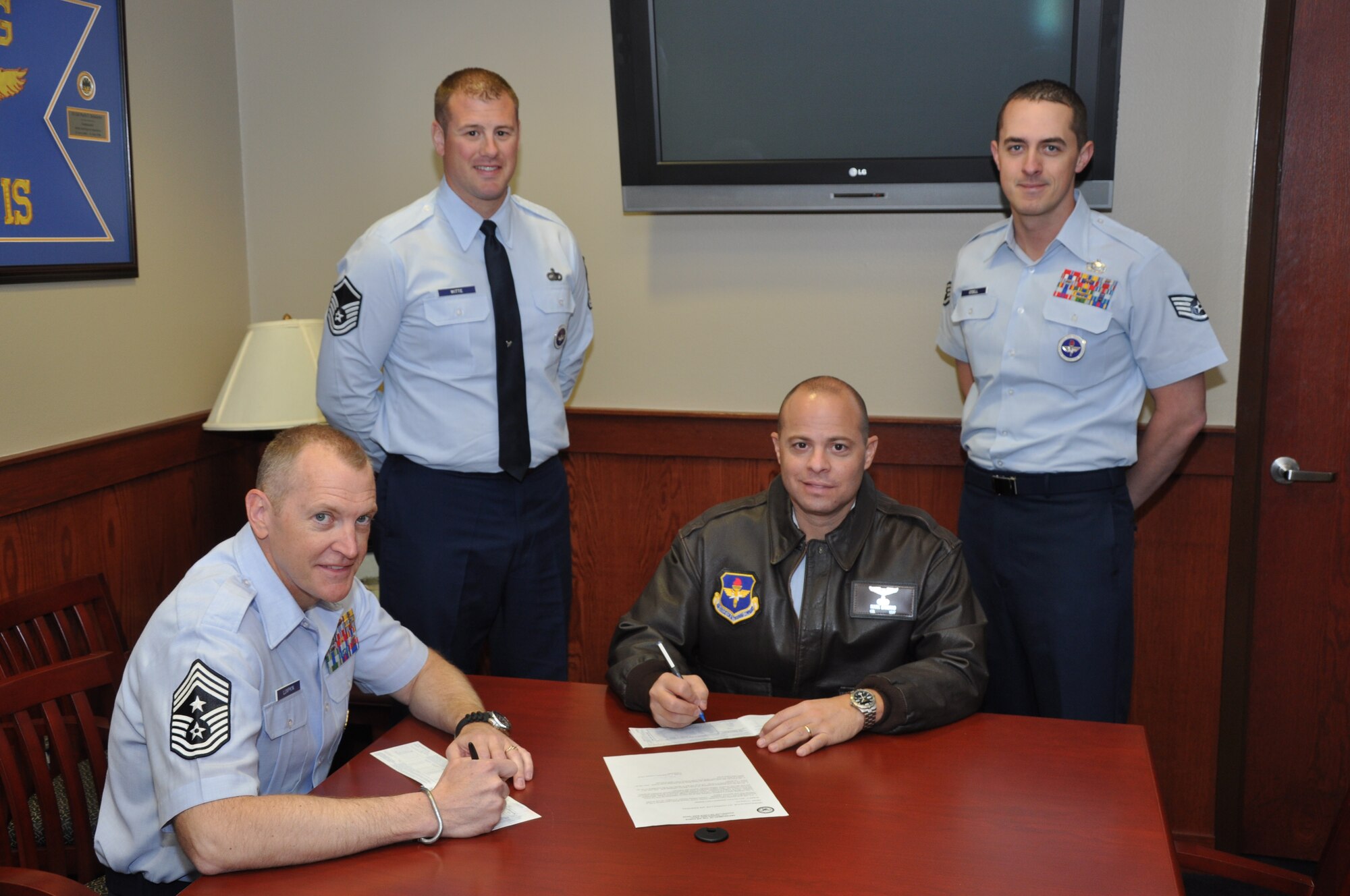 GOODFELLOW AIR FORCE BASE, Texas – Col. Mark Damiano, 17th Training Wing Commander, and Chief Master Sgt. Scott Lumpkin, 17th Training Wing Command Chief, sign the Air Force Assistance Fund pledge card, at the Norma Brown Building here, Feb. 25. The AFAF raises money for several charities benefiting Air Force members and their families. (U.S. Air Force photo/ Airman 1st Class Joshua Edwards)