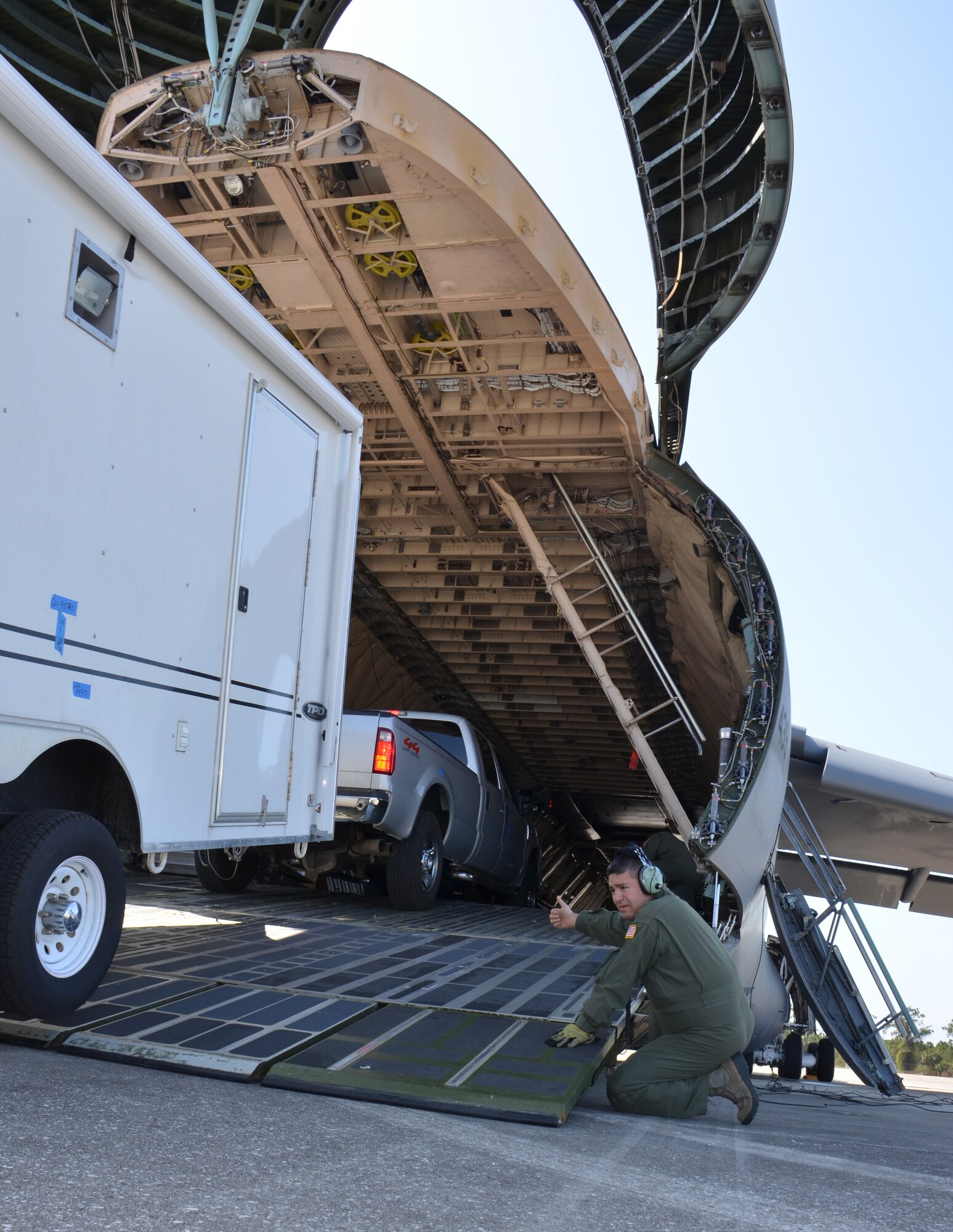 SrA. Yebel Martinez, 337th Airlift Squadron loadmaster, assists the FBI with loading a truck aboard an Air Force Reserve Command C-5 Feb. 23, during Patriot Sands 2013, a joint agency exercise designed to train FEMA, the FBI and Airmen in a contingency response environment. (US Air Force photo/MSgt. Andrew Biscoe)