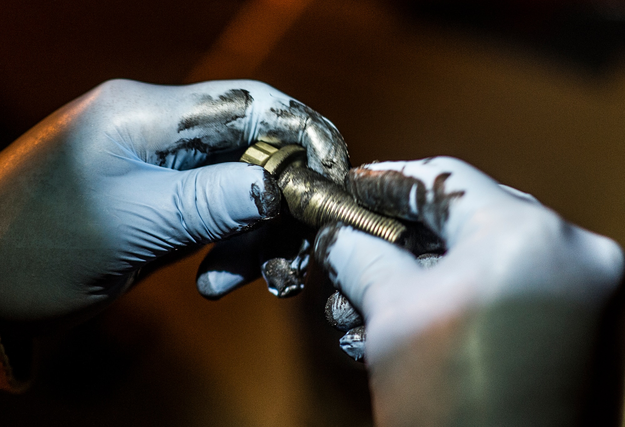 A U.S. Air Force Airman greases a bolt before replacing the brakes of an AC-130U gunship on the flightline at Hurlburt Field, Fla., Feb. 20, 2013. The 1st Special Operations Aircraft Maintenance Squadron is a special operations force enabler and its mission is to generate combat capability in the form of safe and reliable special mission aircraft. (U.S. Air Force photo/Airman 1st Class Christopher Callaway)