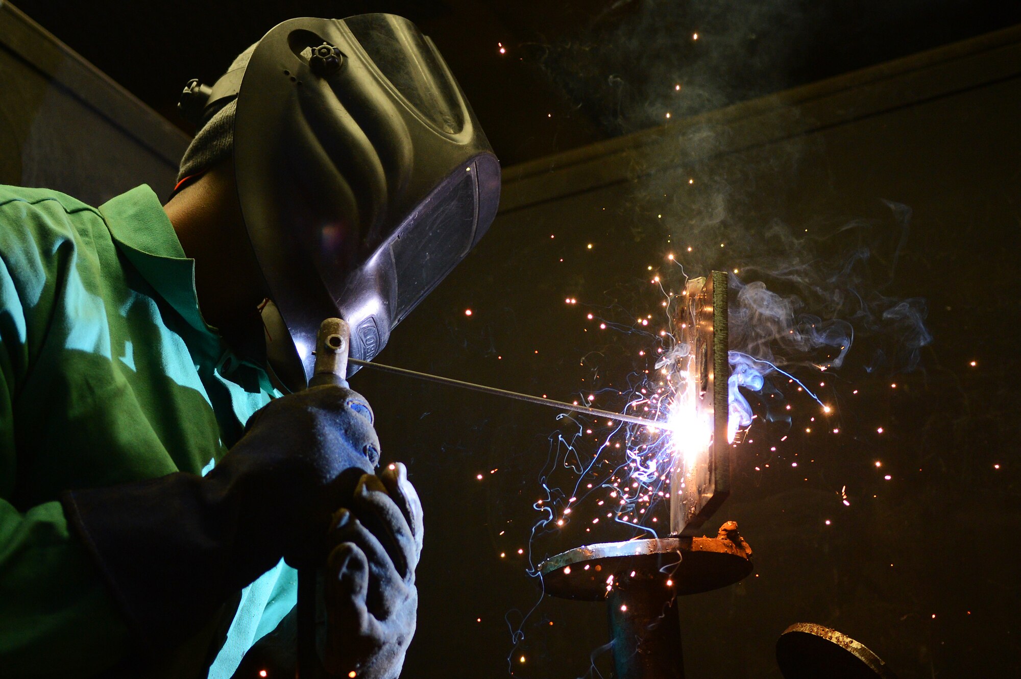 Jeremy Daney, Central Carolina Technical College structural welding student, works on a v-grooved plate for his class at Central Carolina Technical College, Sumter, S.C., Feb. 20, 2013.  U.S. Air Force Master Sgt. Ret. Walter Lumbert, aerospace ground equipment technician, who served for 18 years at Shaw, now instructs the course at CCTC.  Lumbert attained his certification while enlisted and upon his retirement was offered the position to build up the welding program at CCTC. (U.S. Air Force photo by Airman 1st Class Nicole Sikorski/Released)