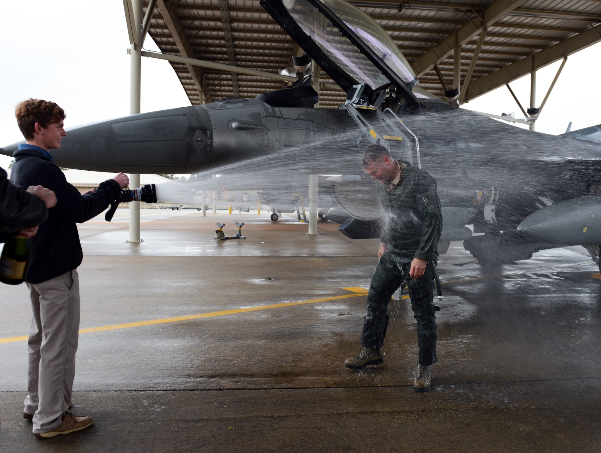 U.S. Air Force Lt. Col. Douglass White, 482nd Operations Group Detachment 1 reservist, gets a ceremonial hosing down from his son Noah White at Shaw Air Force Base, S.C., Feb. 19, 2013.  After serving more than 28 years, White completed his final flight as a pilot in the U.S. Air Force and is scheduled to retire in April. This is White’s second time retiring; he retired from active duty in 2004 and is retiring now as a reservist.(U.S. Air Force photo by Senior Airman Tabatha Zarrella/Released)