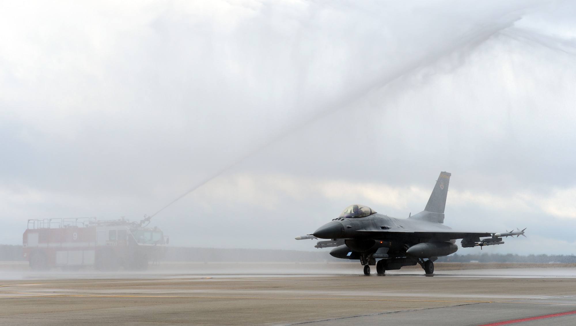 Fire trucks create a water arch for U.S. Air Force Lt. Col. Douglass White, 482nd Operations Group Detachment 1 reservist, at Shaw Air Force Base, S.C., Feb. 19, 2013. After serving more than 28 years, White completed his final flight as a pilot in the U.S. Air Force and is scheduled to retire in April. This is White’s second time retiring; he retired from active duty in 2004 and is retiring now as a reservist. (U.S. Air Force photo by Senior Airman Tabatha Zarrella/Released)