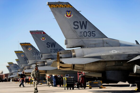 U.S. Air force crew chiefs assigned to the 20th Aircraft Maintenance Squadron perform their final checks before launching eight F-16 Fighting Flacon jets assigned to the 79th Fighter Squadron ‘Tigers’ during day one of Red Flag 13-3, Feb. 25, 2013. The ‘Tigers’ launched a total of 16 times during day and night time missions to kick off the exercise. The unit has approximately 15 F-16 Fighting Falcons on the ground at Nellis AFB and 35 pilots slated to fly throughout the three-week long exercise. (U.S. Air Force photo by Staff Sgt. Kenny Holston/Released)