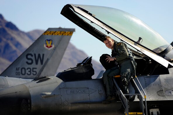 A 79th Fighter Squadron ‘Tigers’ pilot climbs into the cockpit of his F-16 Fighting Falcon prior to takeoff during day one of Red Flag 13-3, Feb. 25, 2013. The ‘Tigers’ launched a total of 16 times during day and nighttime missions to kick off the exercise. The unit has approximately 15 F-16 Fighting Falcons on the ground at Nellis AFB and 35 pilots slated to fly throughout the three-week long exercise. (U.S. Air Force photo by Staff Sgt. Kenny Holston/Released) 