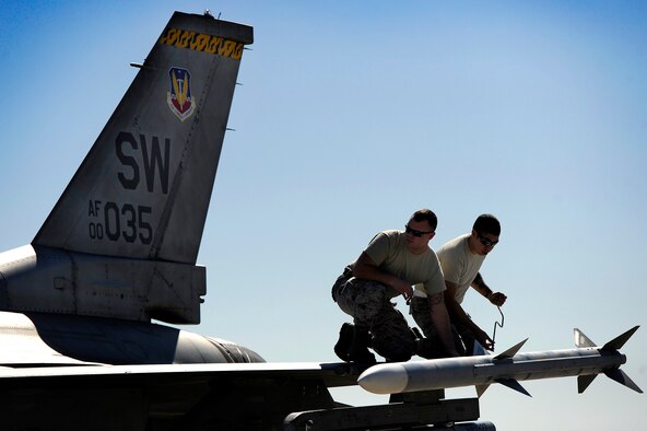 U.S. Air force aircraft maintainers assigned to the 20th Aircraft Maintenance Squadron prepare a 79th Fighter Squadron ‘Tigers’ F-16 Fighting Falcon for one of the first missions to kick off Red Flag 13-3, Feb. 25, 2013. The ‘Tigers’ launched a total of 16 times during day and nighttime missions to kick off the exercise. The unit has approximately 15 F-16 Fighting Falcons on the ground at Nellis AFB and 35 pilots slated to fly throughout the three-week long exercise. (U.S. Air Force photo by Staff Sgt. Kenny Holston/Released) 