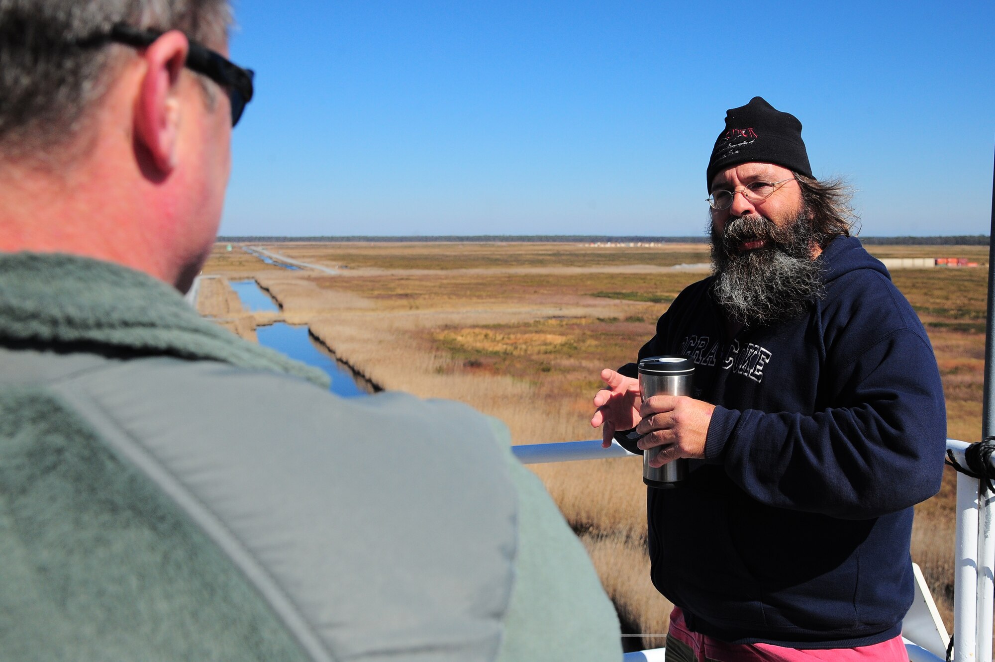 David Carroll, Air Combat Command Dare County Bombing Range environmental control operator, speaks to Timothy Edwards, 4th Fighter Wing ground safety manager, about range conditions during an inspection at the range in Stumpy Point, N.C., Feb. 21, 2013. According to Edwards, the range is the primary location for air-to-surface target training on the east coast. (U.S. Air Force photo/Airman 1st Class Aubrey White/Released)
