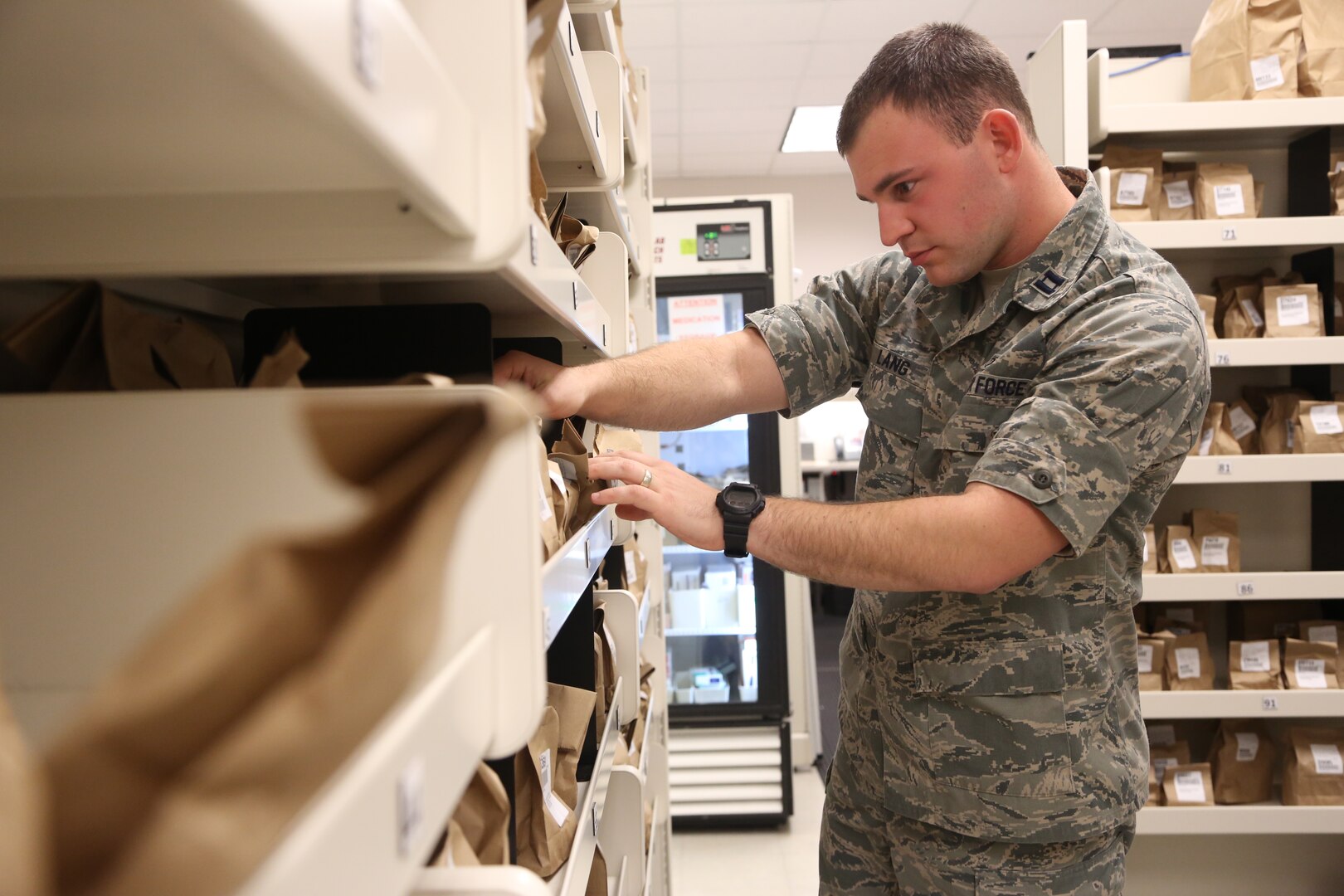 U.S. Air Force Capt. David Lang, 359th Medical Operations Squadron officer in charge of clinic pharmacy, searches for a prescription in the Exchange pharmacy Feb. 12, 2013, at Joint Base San Antonio-Randolph. (U.S. Air Force photo by Joshua Rodriguez/ Released)